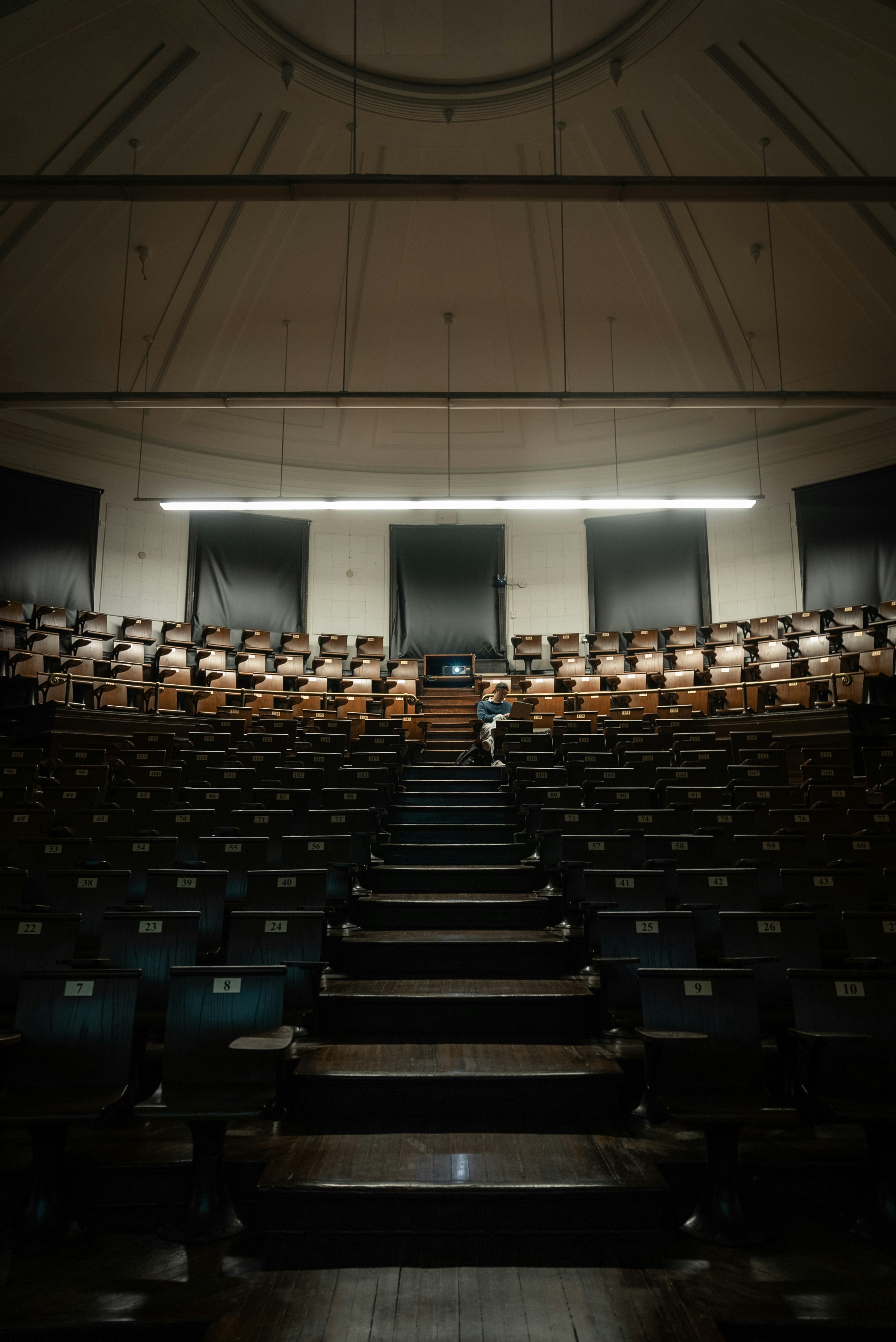 An empty auditorium with rows of empty seats