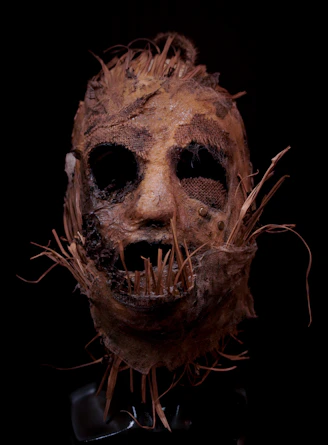 A creepy looking mask with hair on it