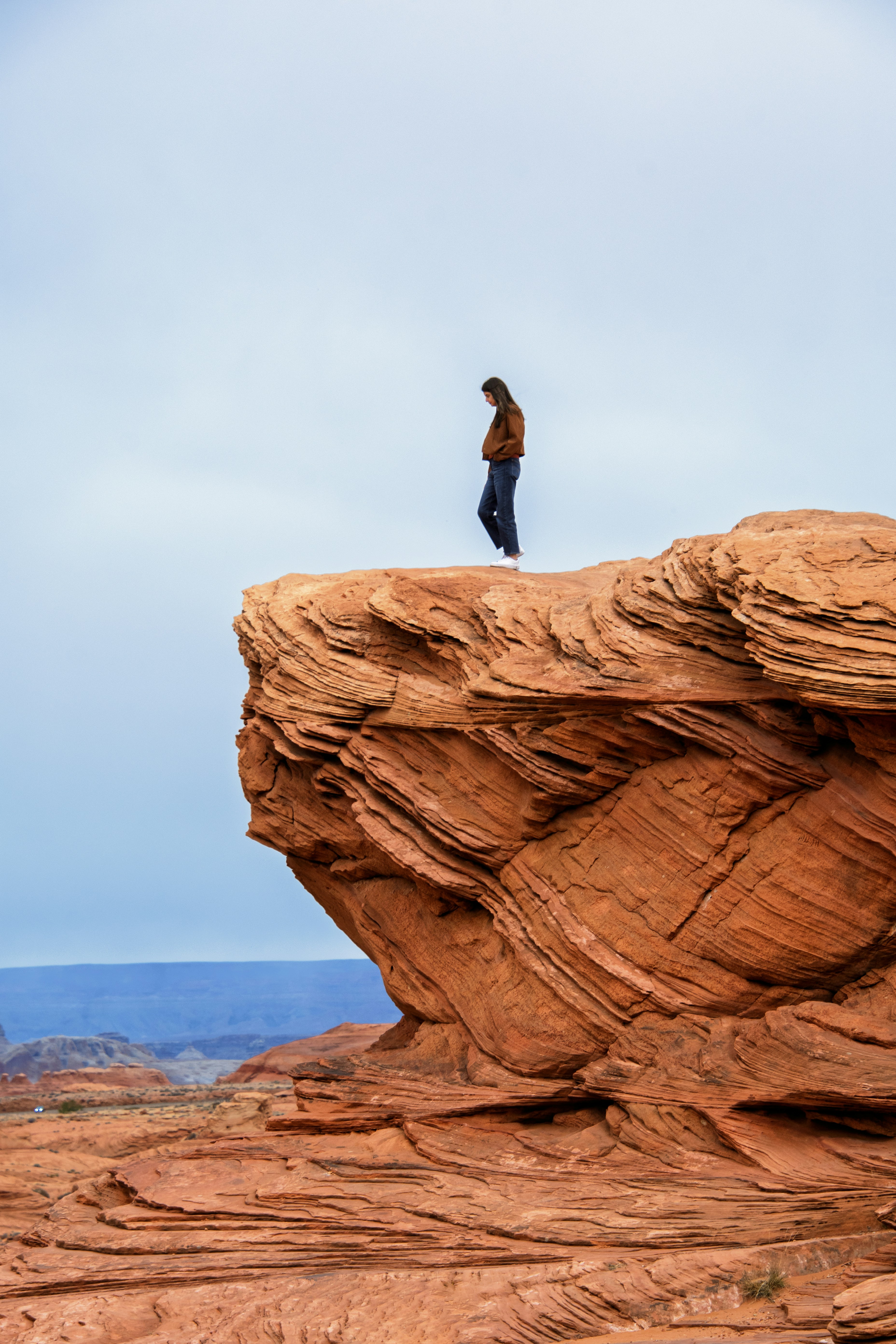 A person standing on top of a rock formation
