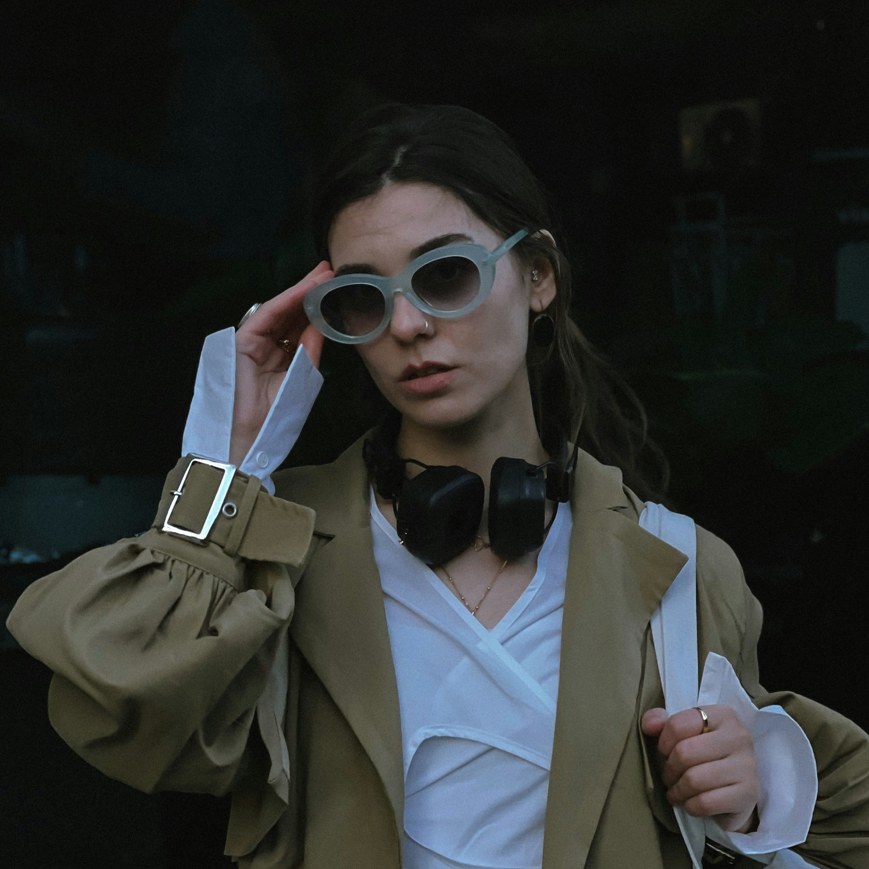 A woman wearing sunglasses and a bow tie