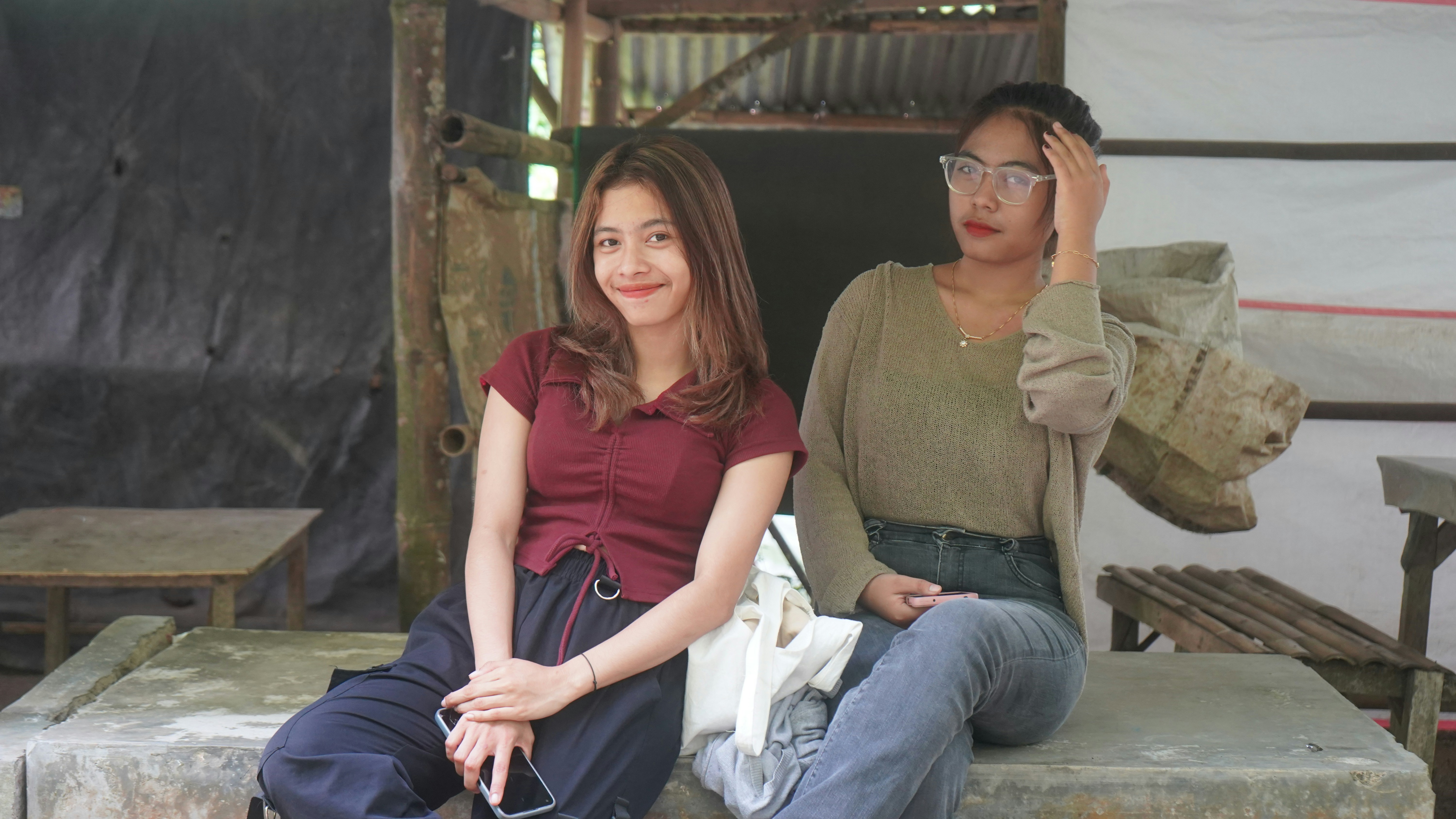 Two friends sitting on rustic bench