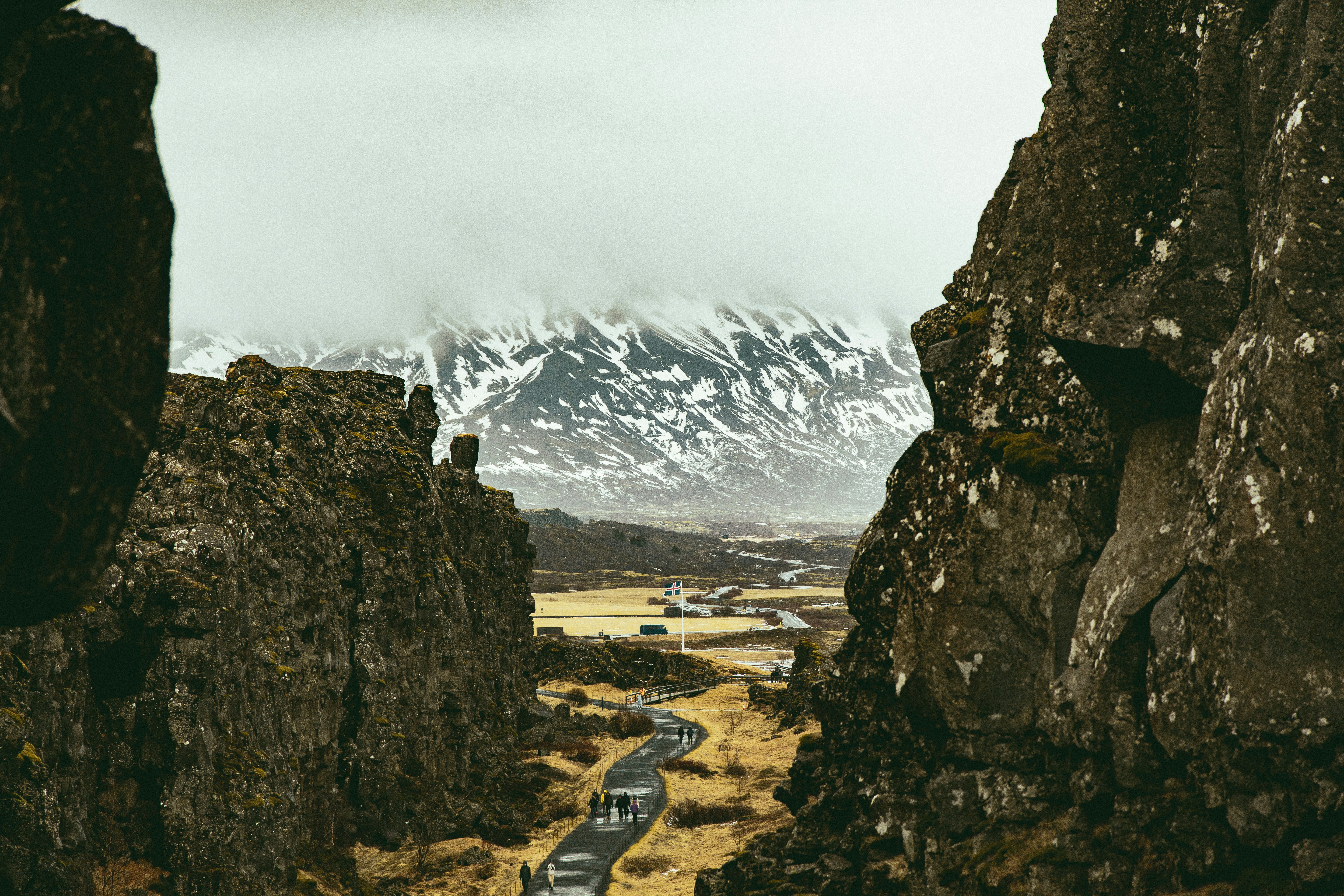 A car driving down a road between two large rocks photo – Free ...