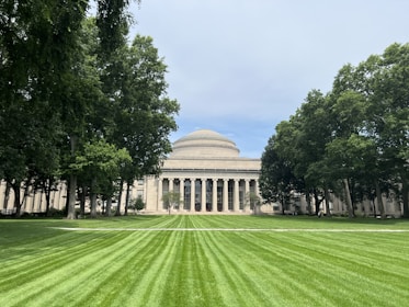 A large grassy field with a building in the background