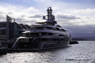 A large boat in the water next to a dock