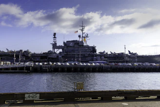 A large ship docked in a harbor next to a pier