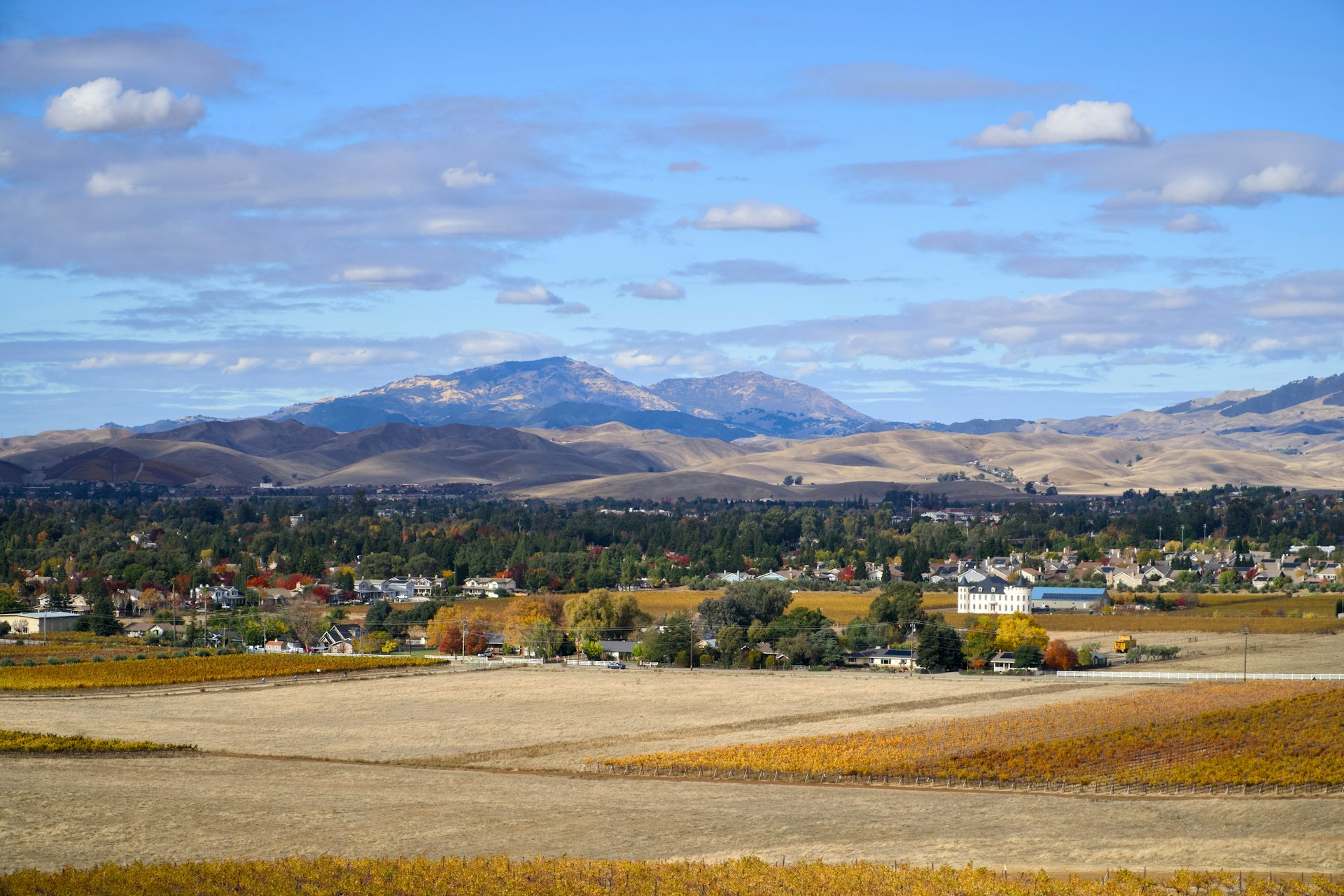 A scenic view of a town and mountains
