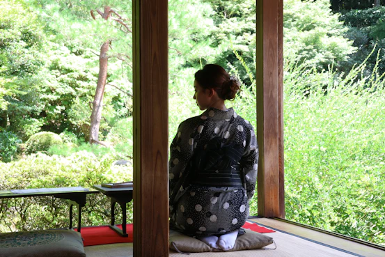 A woman sitting on a mat in a room