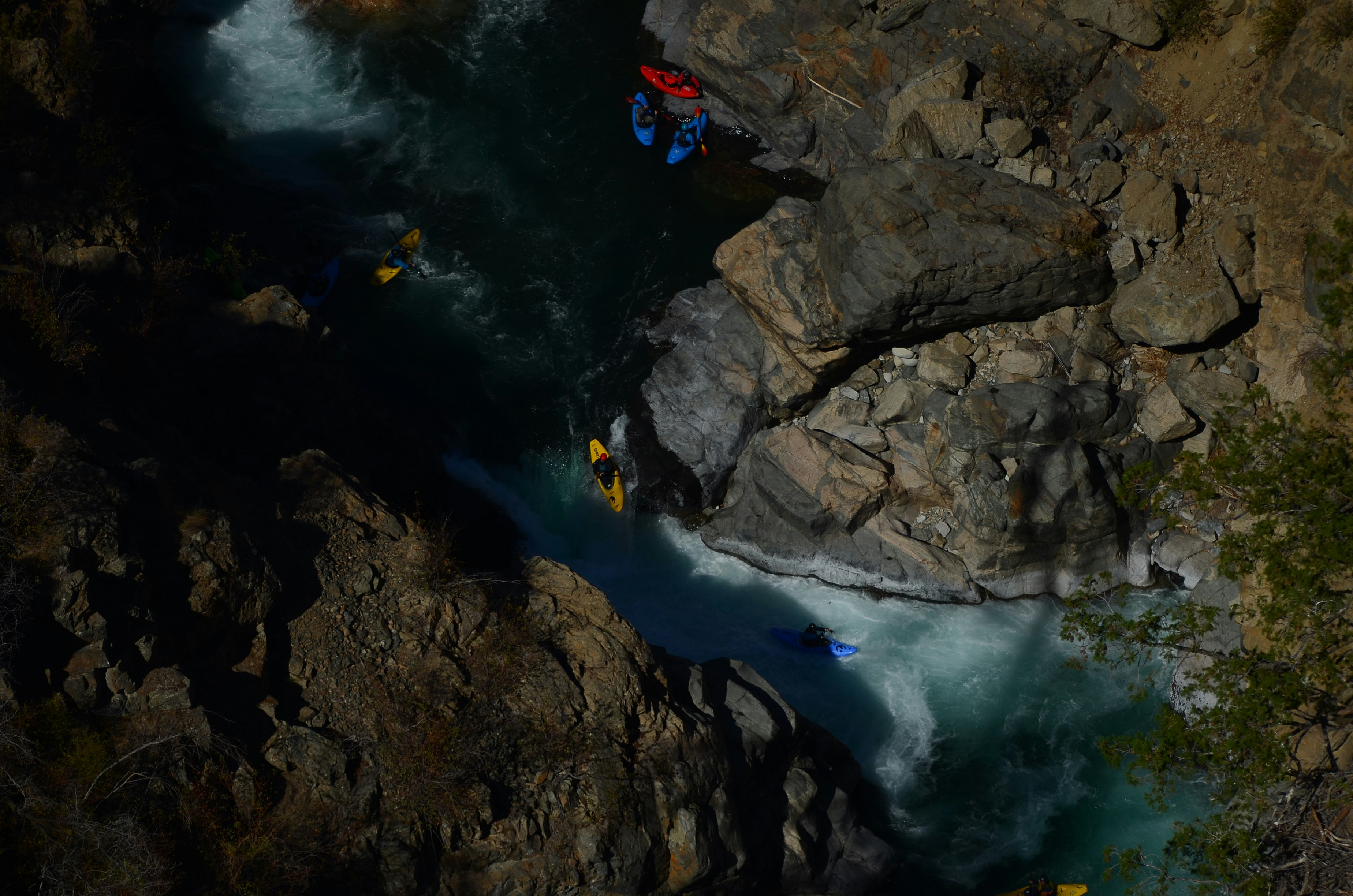 An aerial view of a river with kayakers in it
