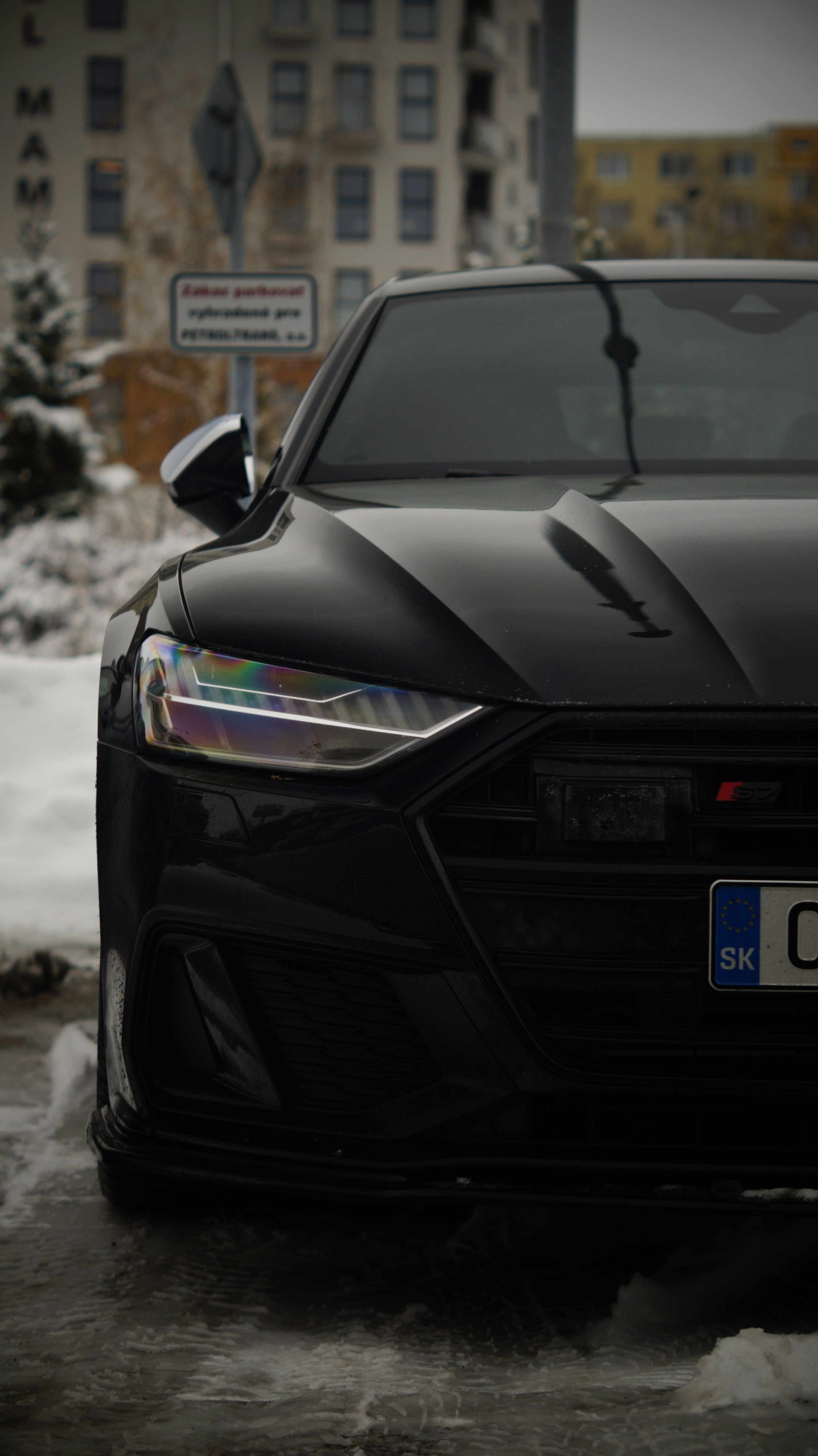A black sports car parked on a snowy street