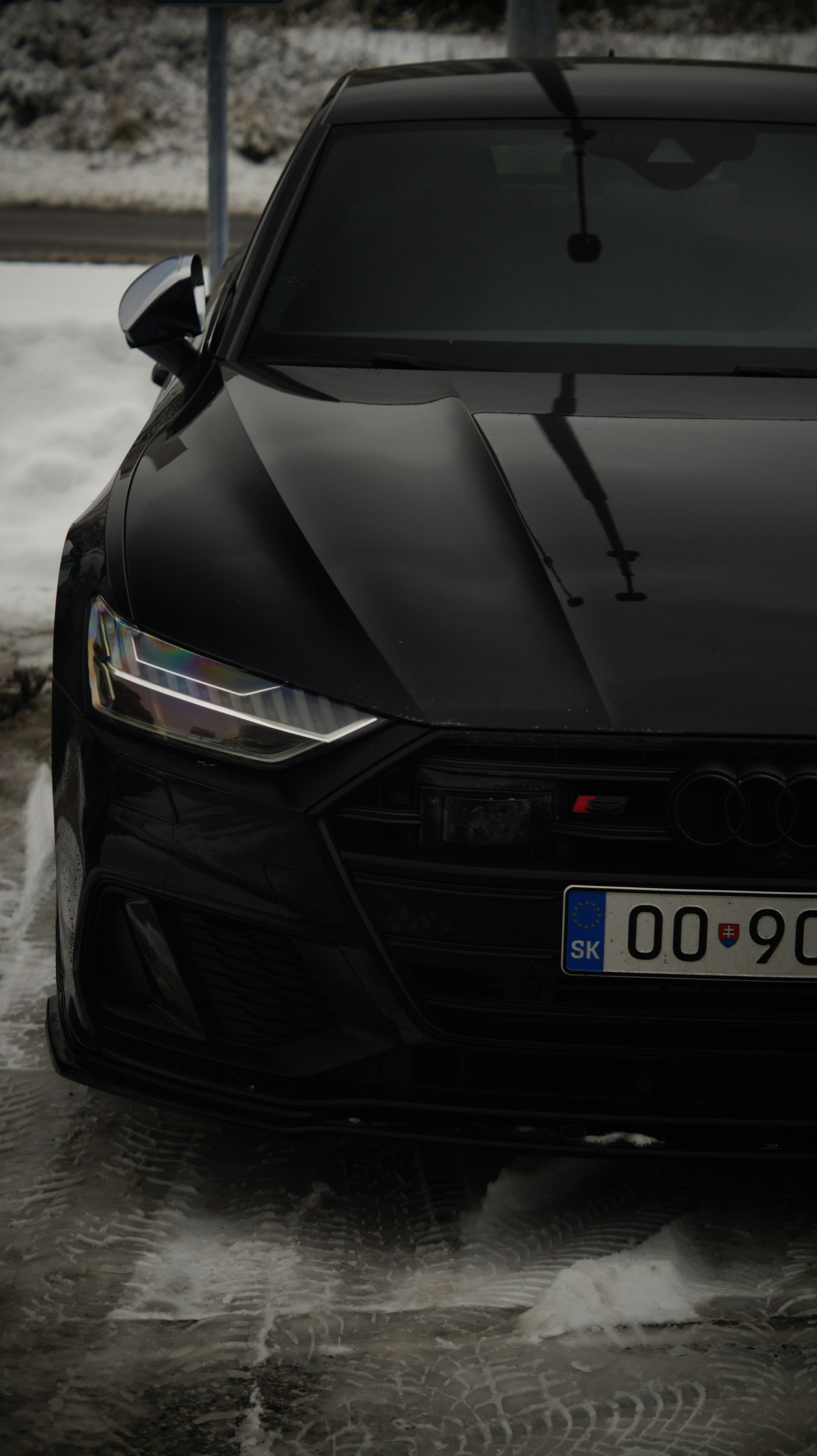 A black car parked in a parking lot