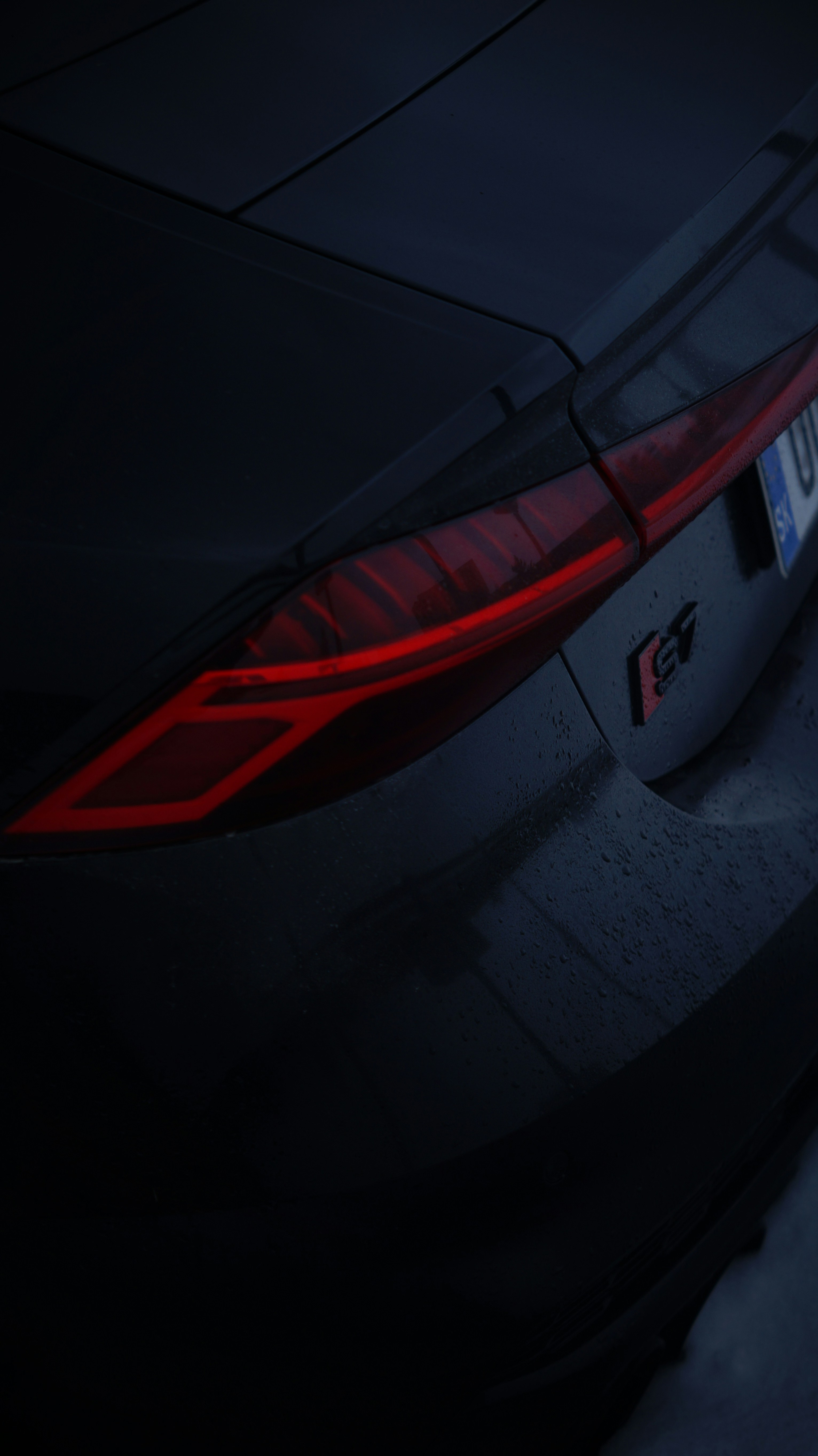 The tail light of a car in the dark