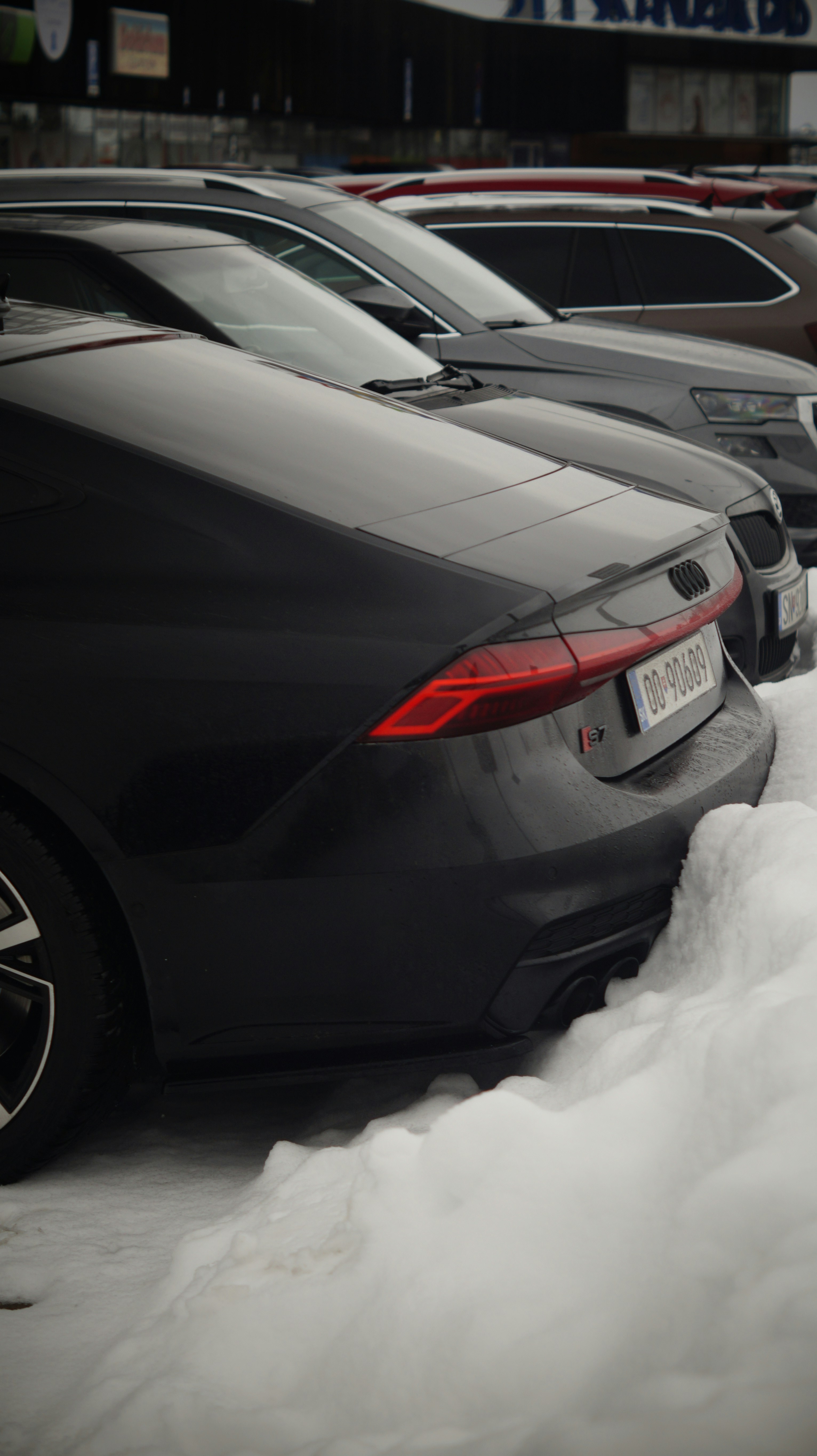 A bunch of cars that are parked in the snow
