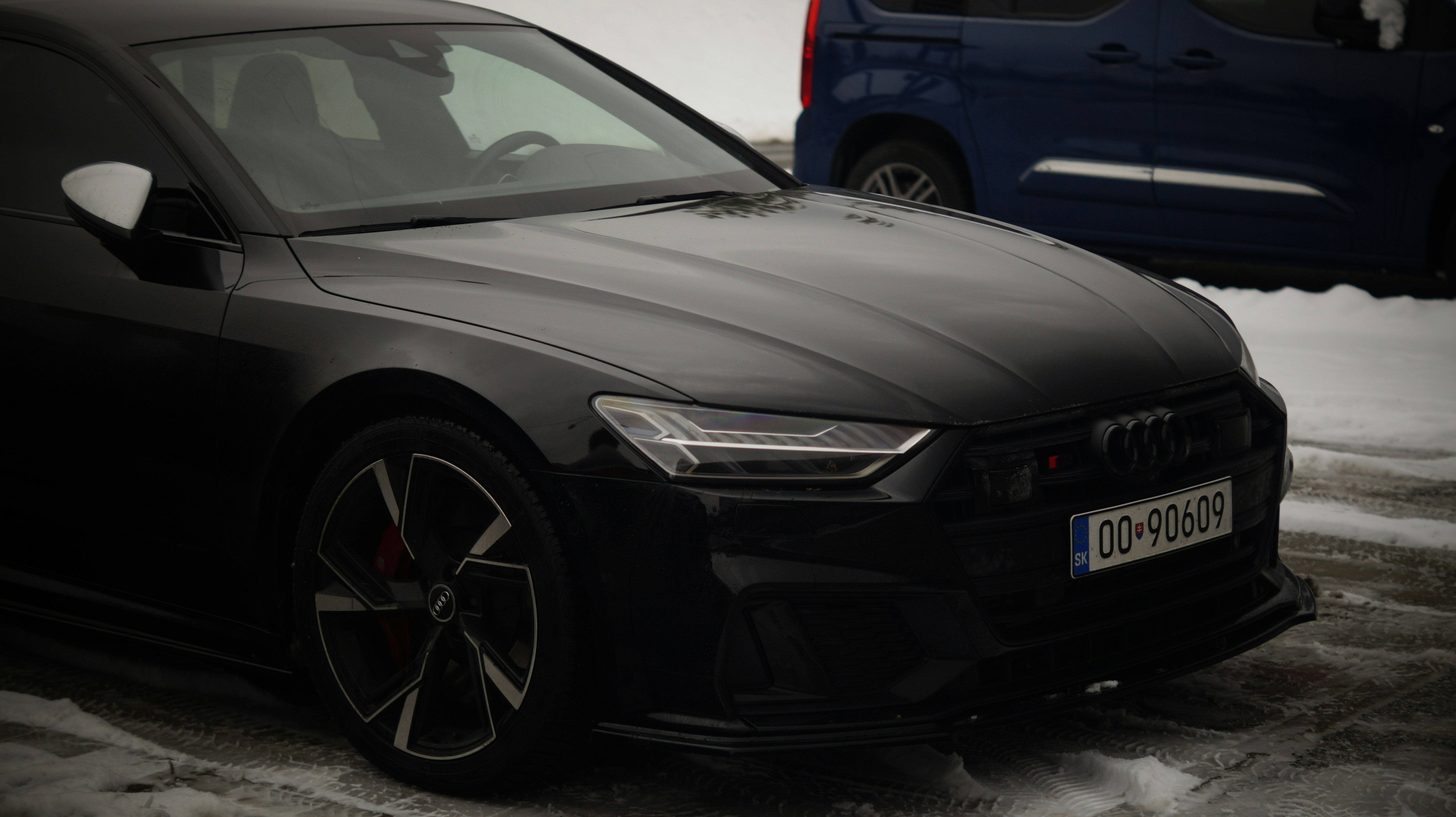 A black car parked next to a blue car
