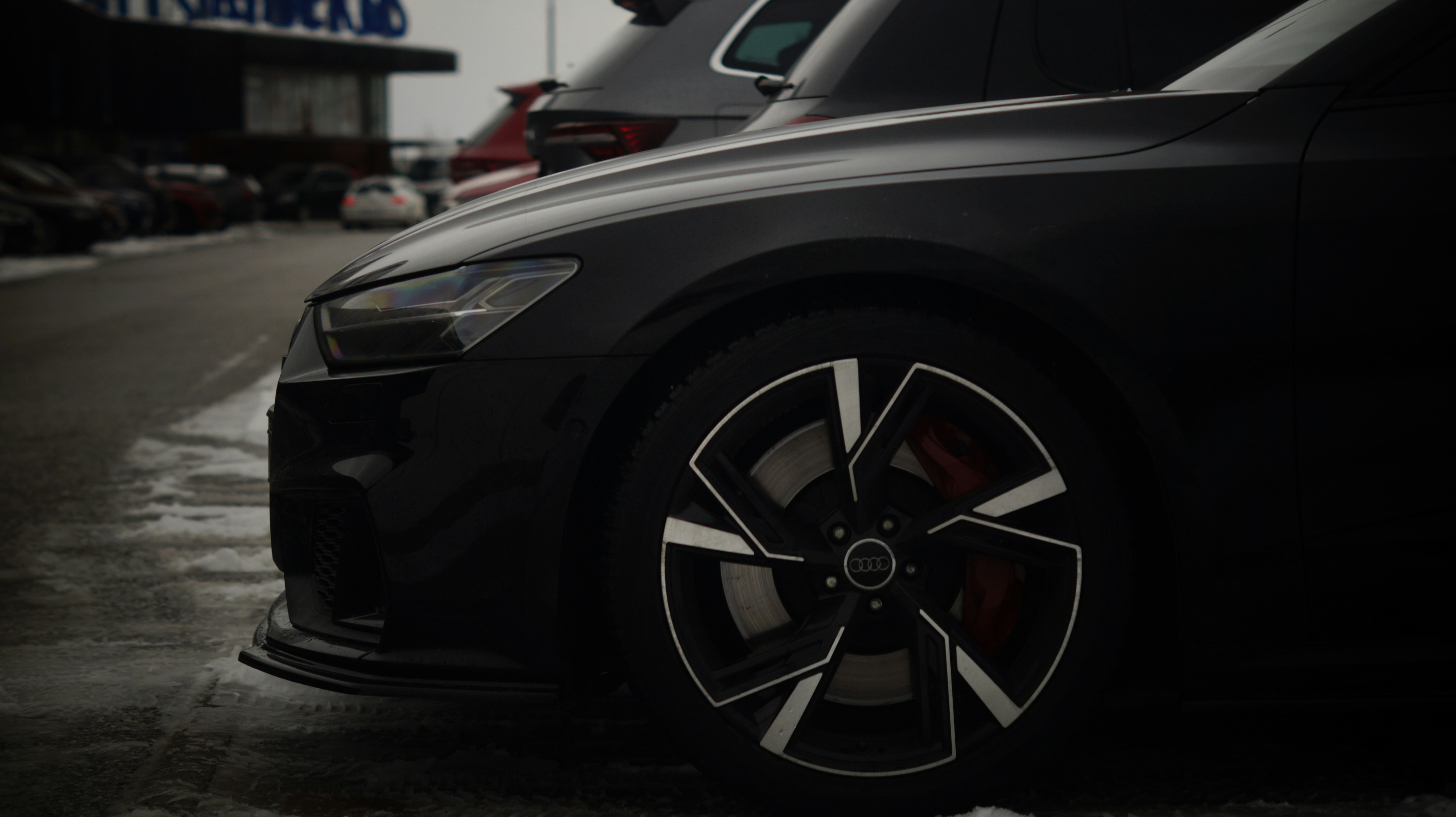 A black car parked in front of a building