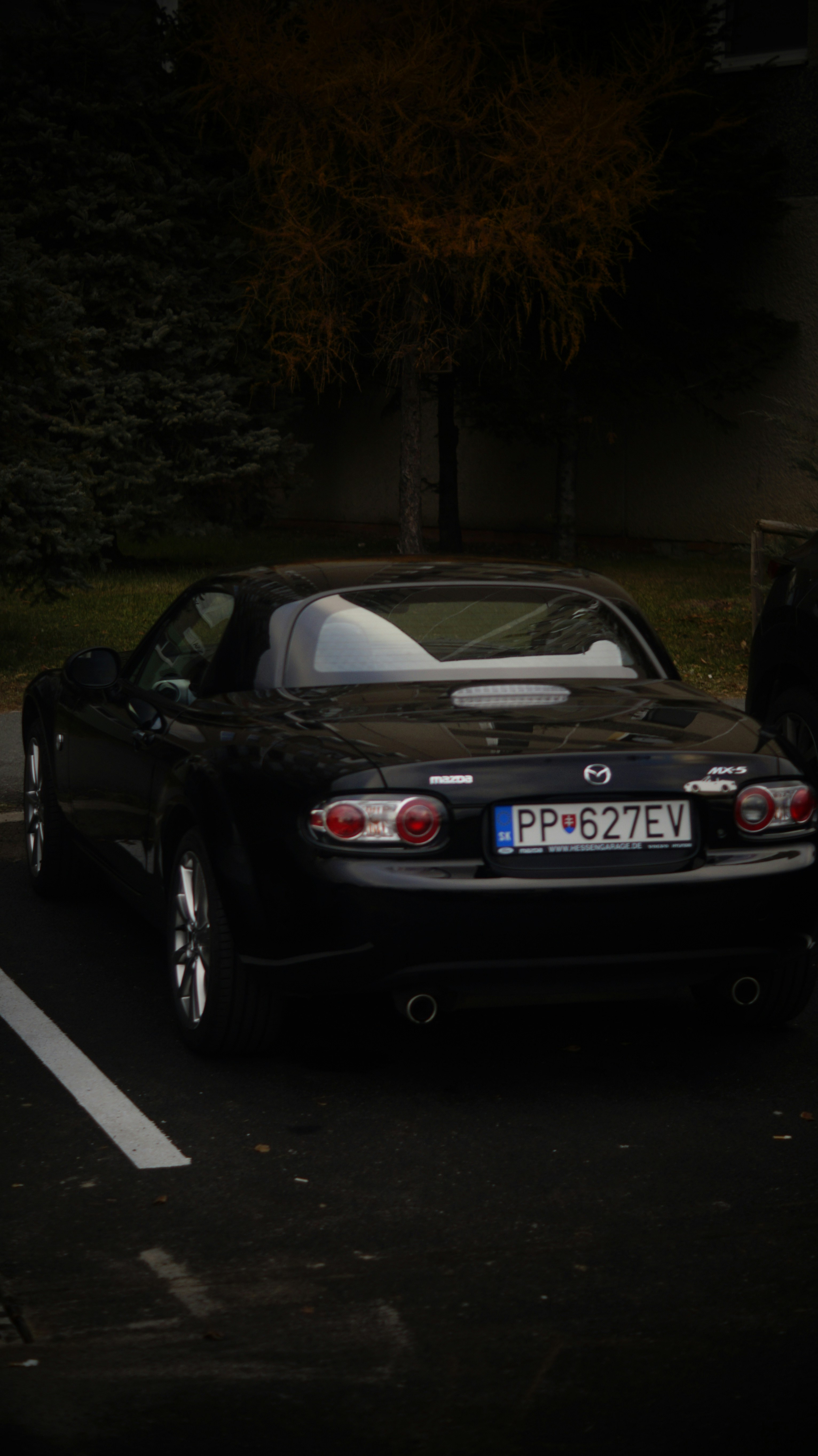 A black sports car parked in a parking lot