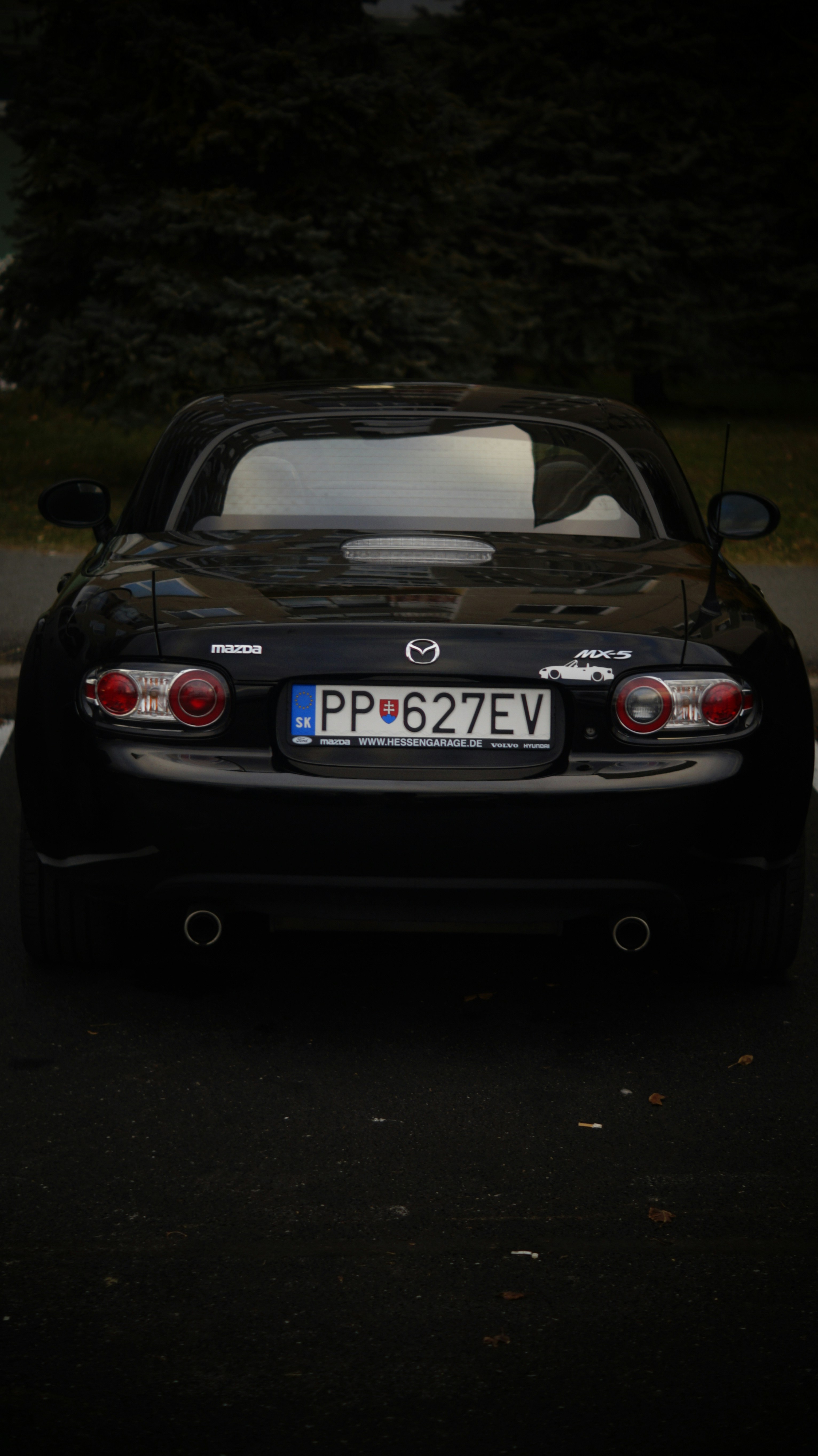 A black sports car parked in a parking lot