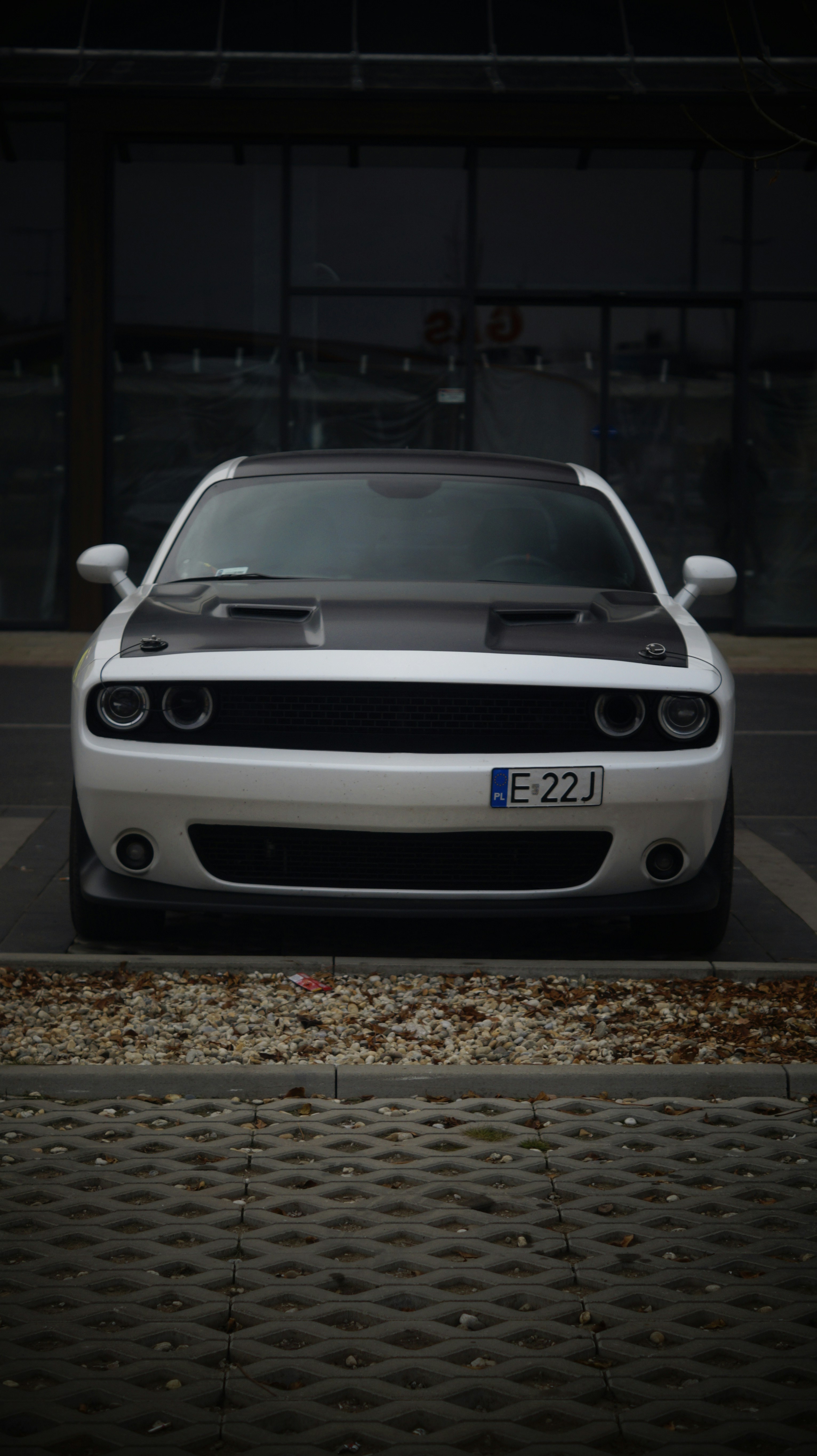 A white sports car parked in a parking lot