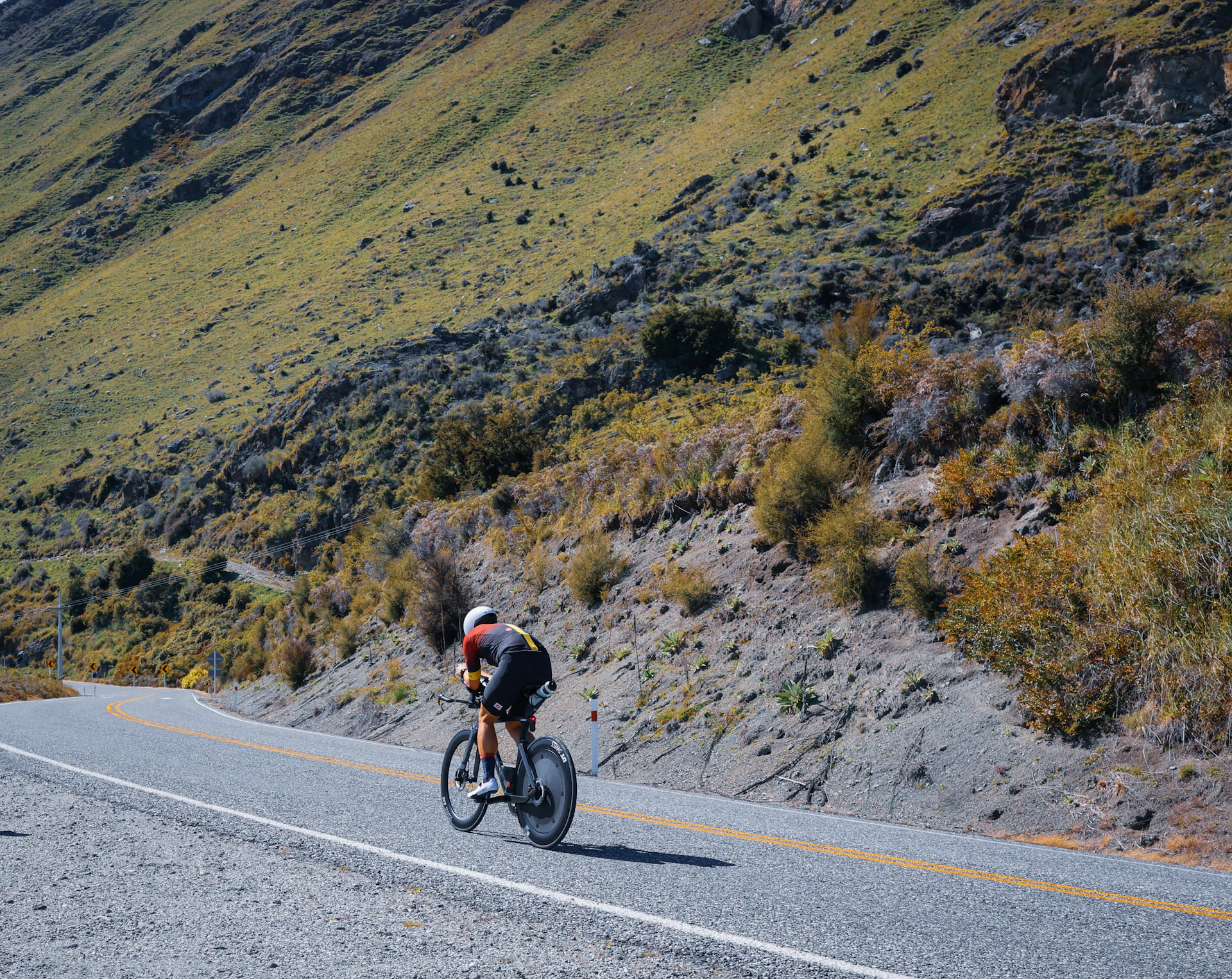 A man riding a bike down a curvy road