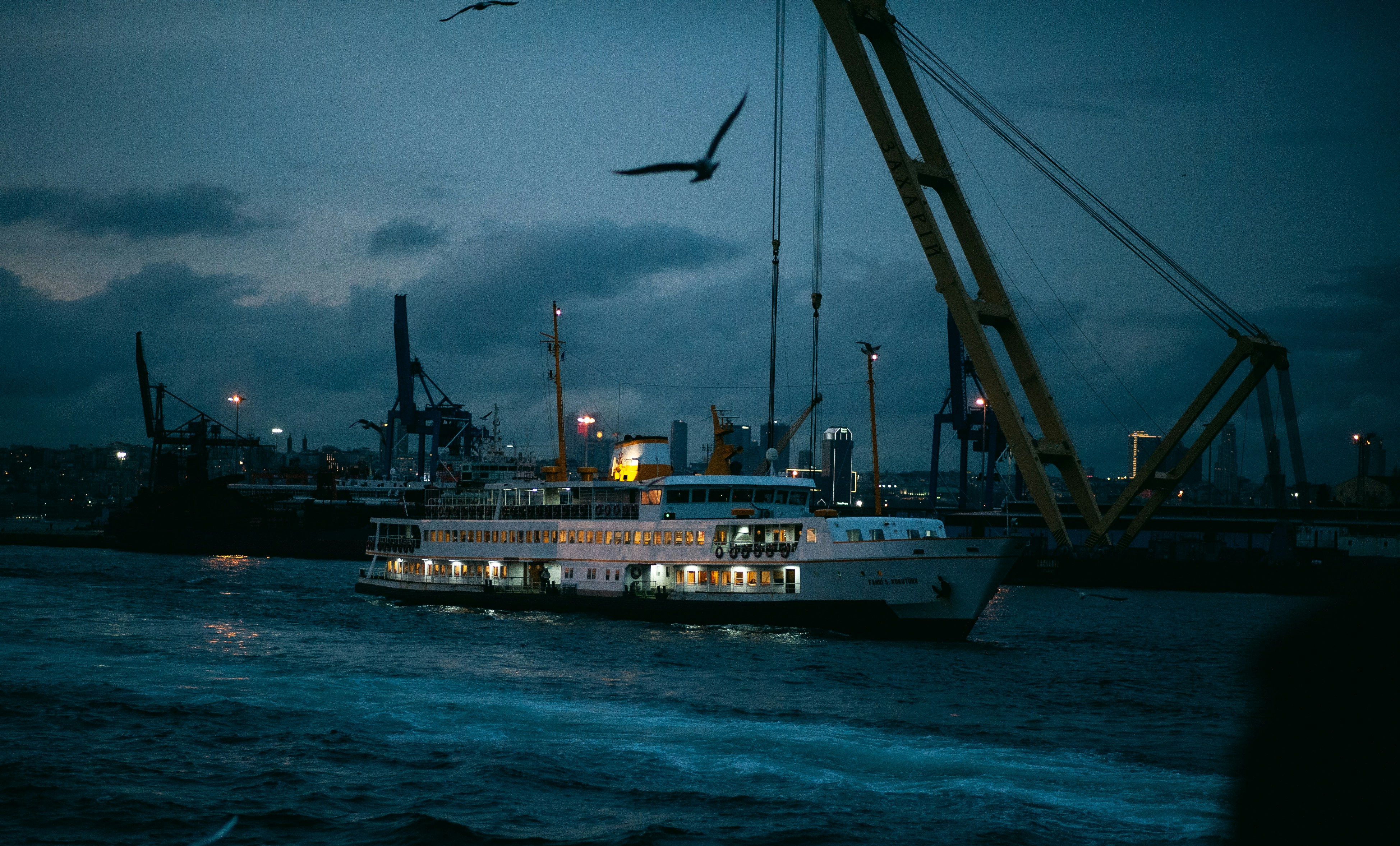 A large boat traveling down a river at night
