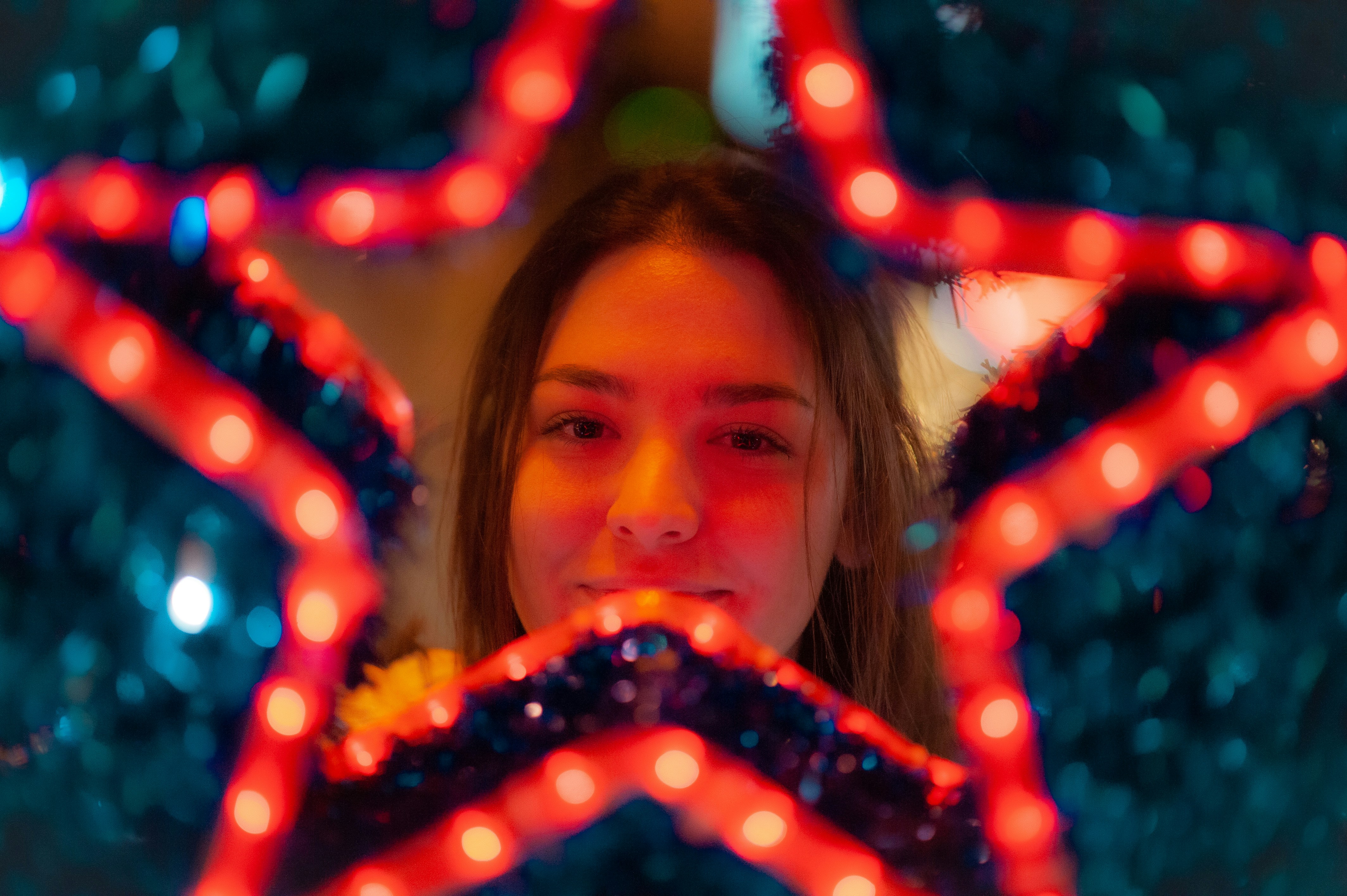 A woman looking through a star shaped mirror
