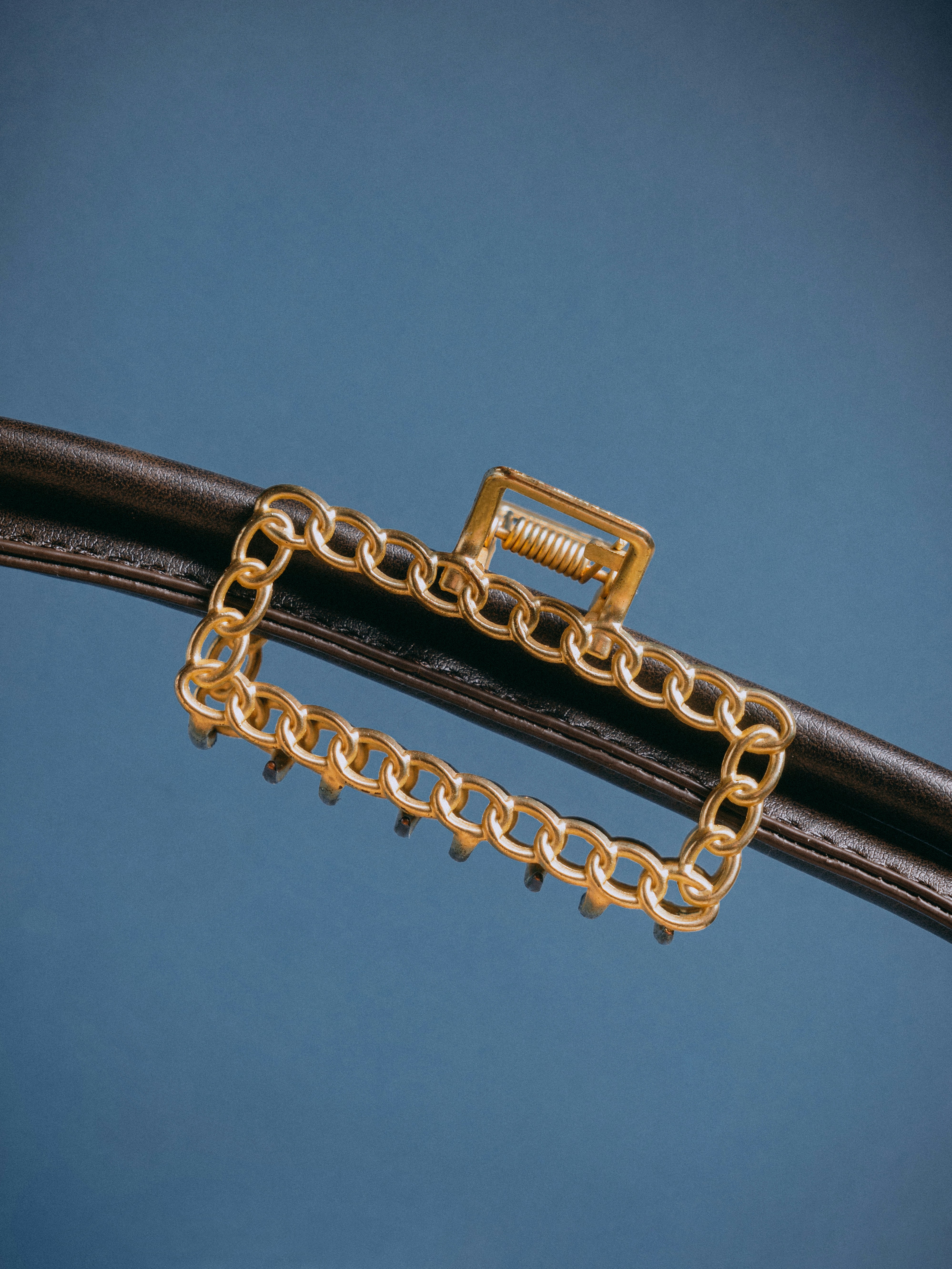 A close up of a pair of gold chains