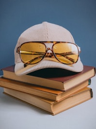 A pair of glasses sitting on top of a stack of books