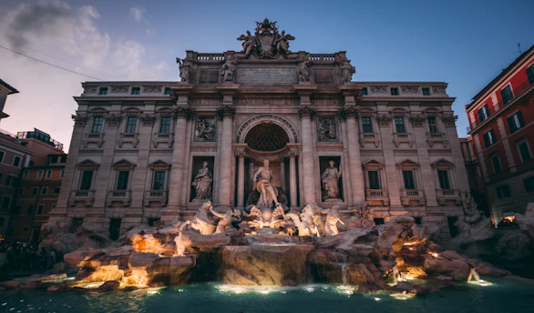 A large building with a fountain in front of it