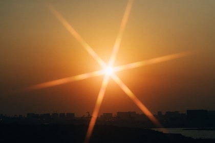 The sun is shining brightly over a city