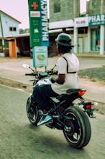 A man riding a motorcycle down a street