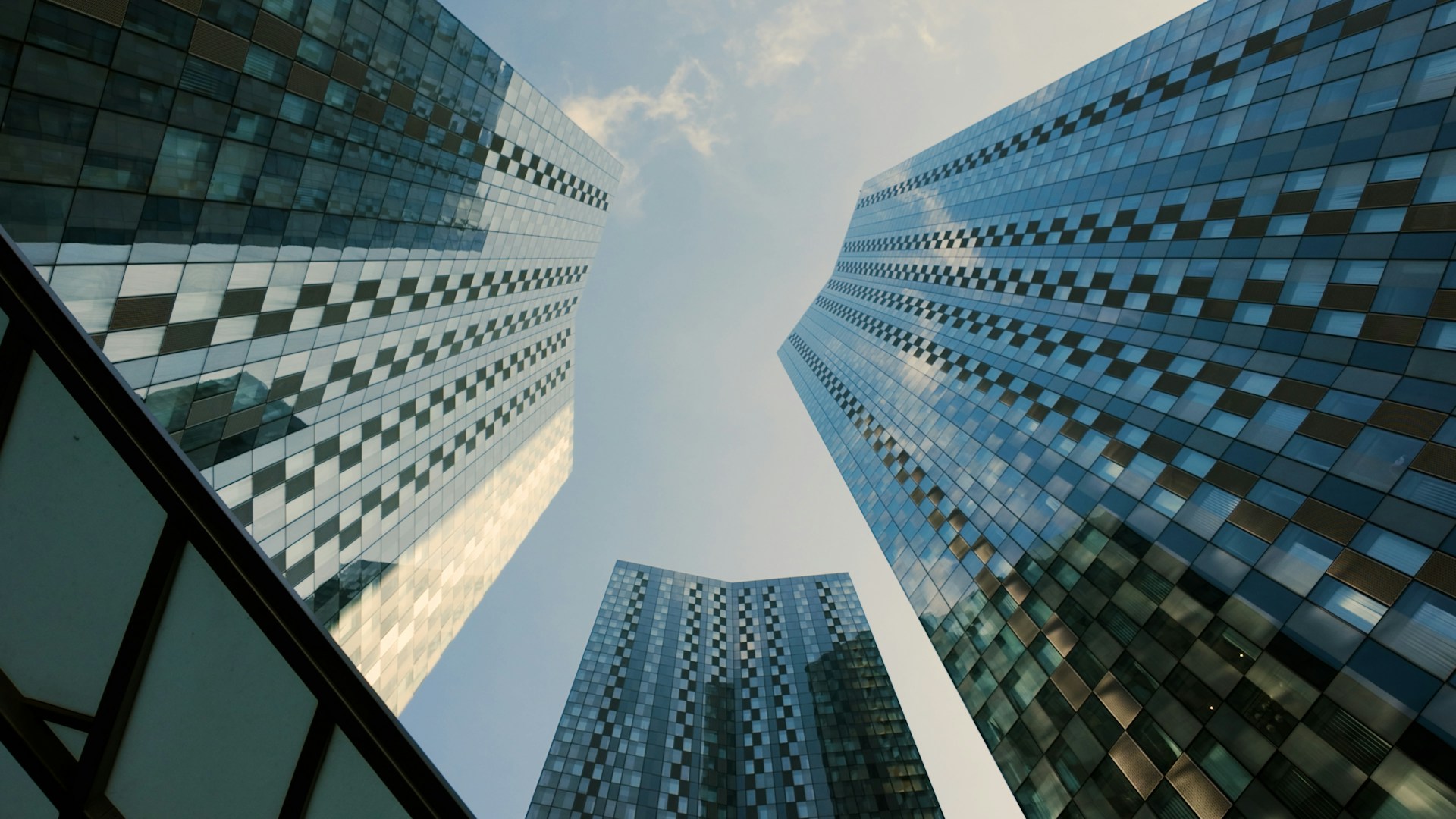 Looking up at a group of tall buildings