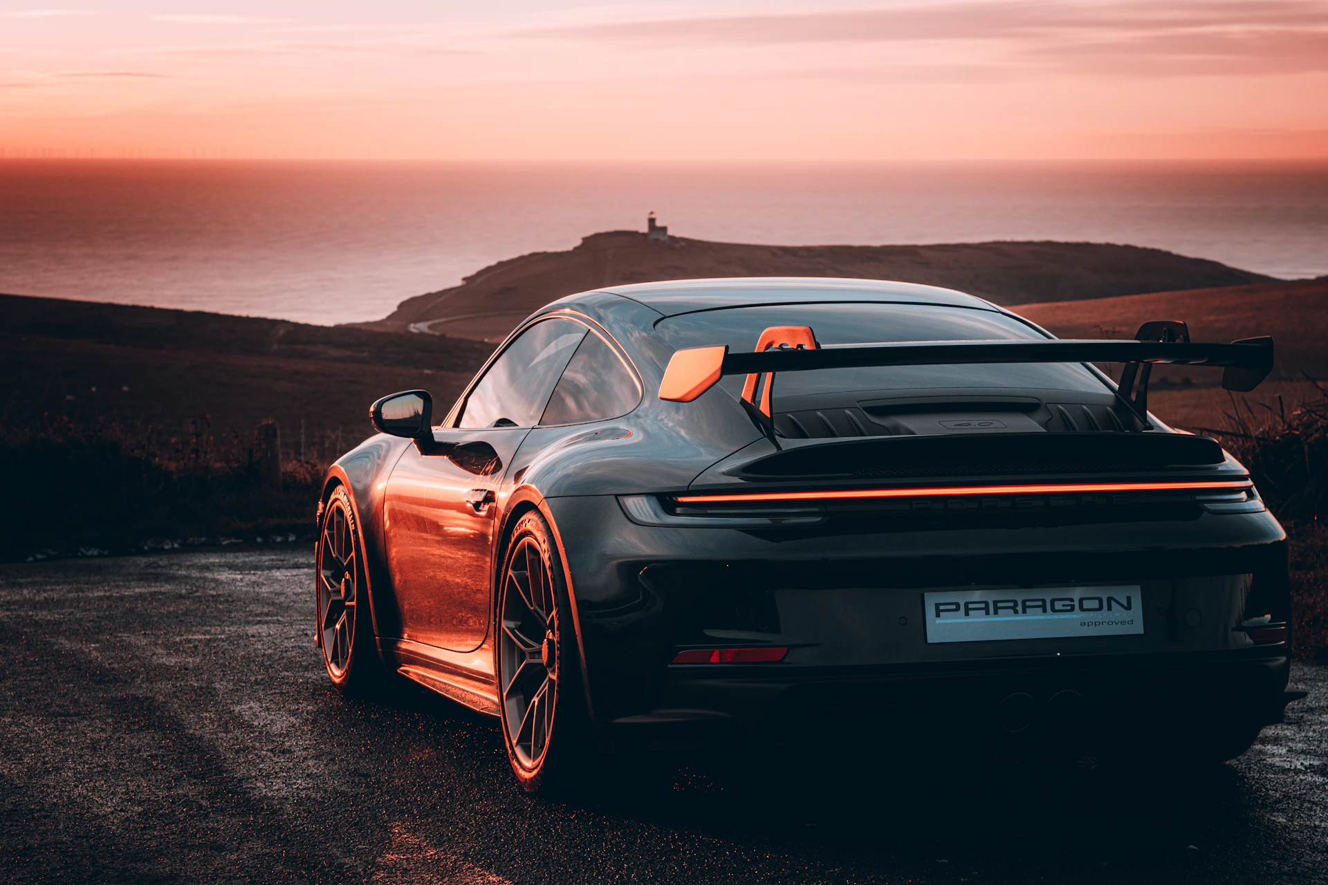 A black sports car parked on the side of a road
