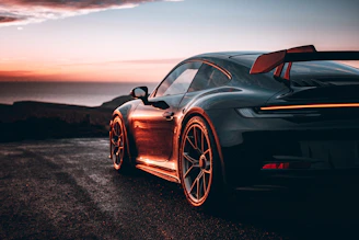 A black sports car parked on the side of a road