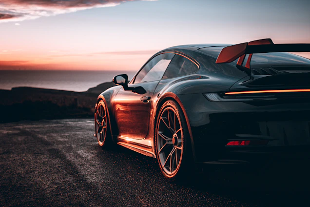 A black sports car parked on the side of a road