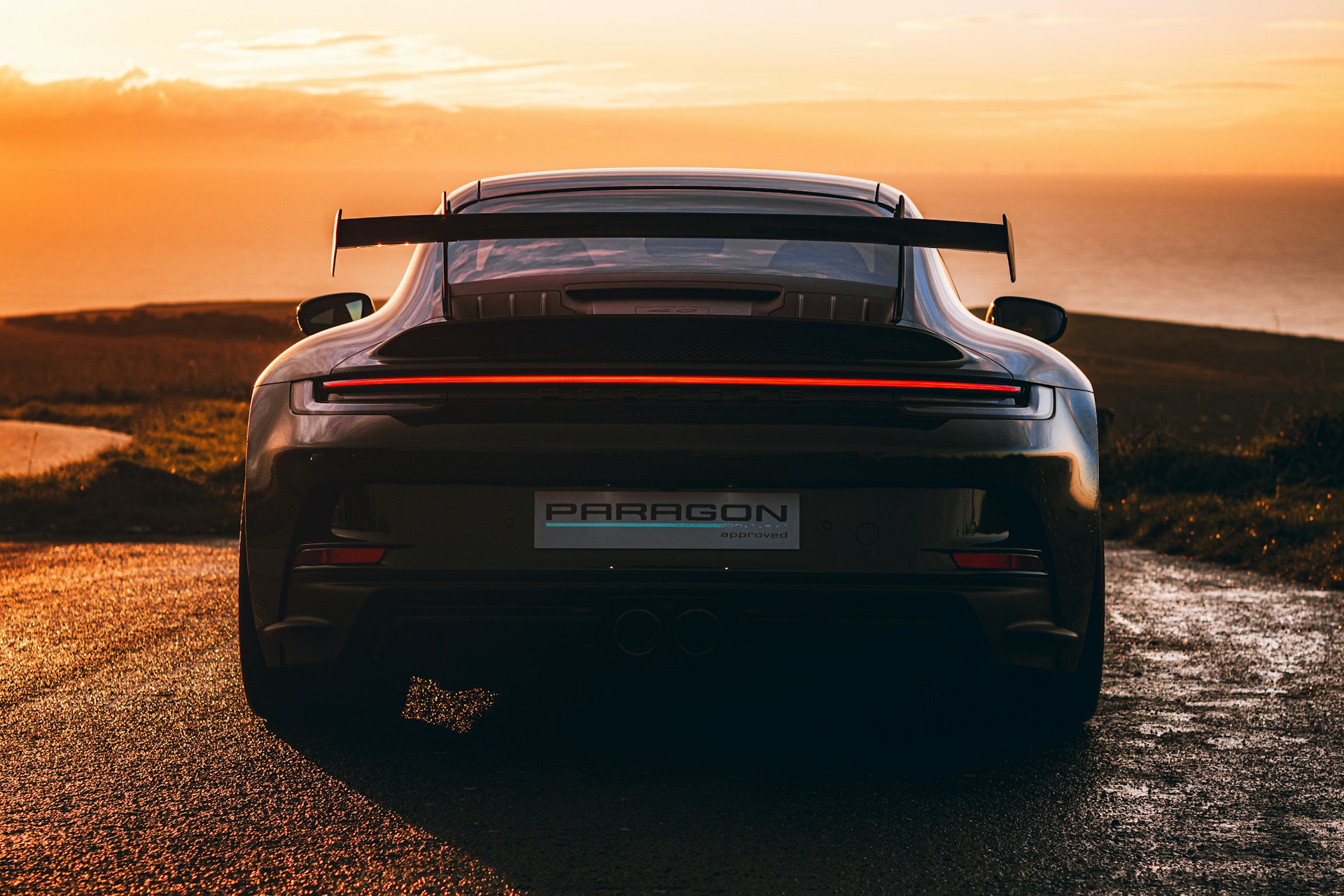 A black sports car parked on the side of a road