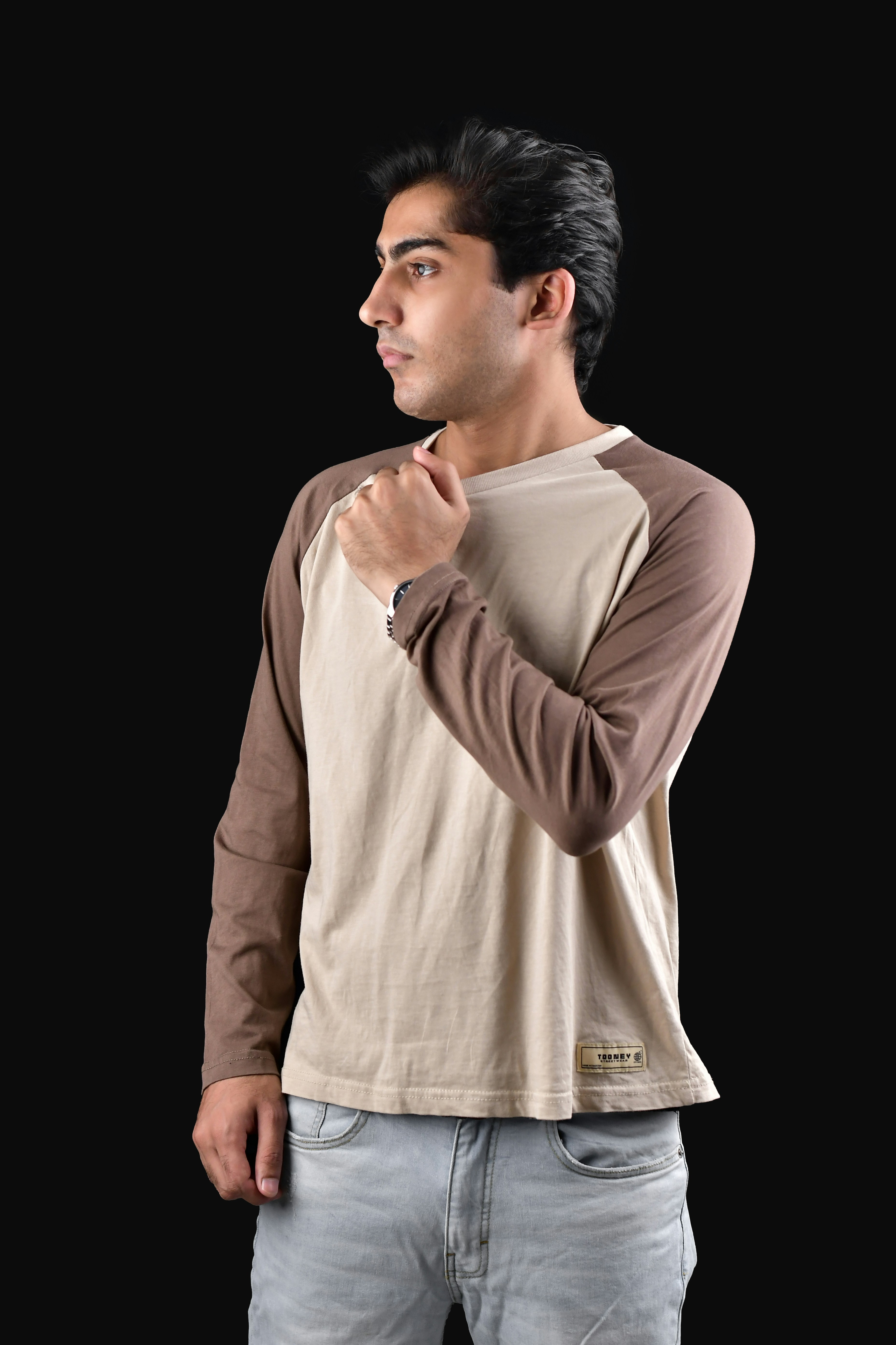 A man standing in front of a black background