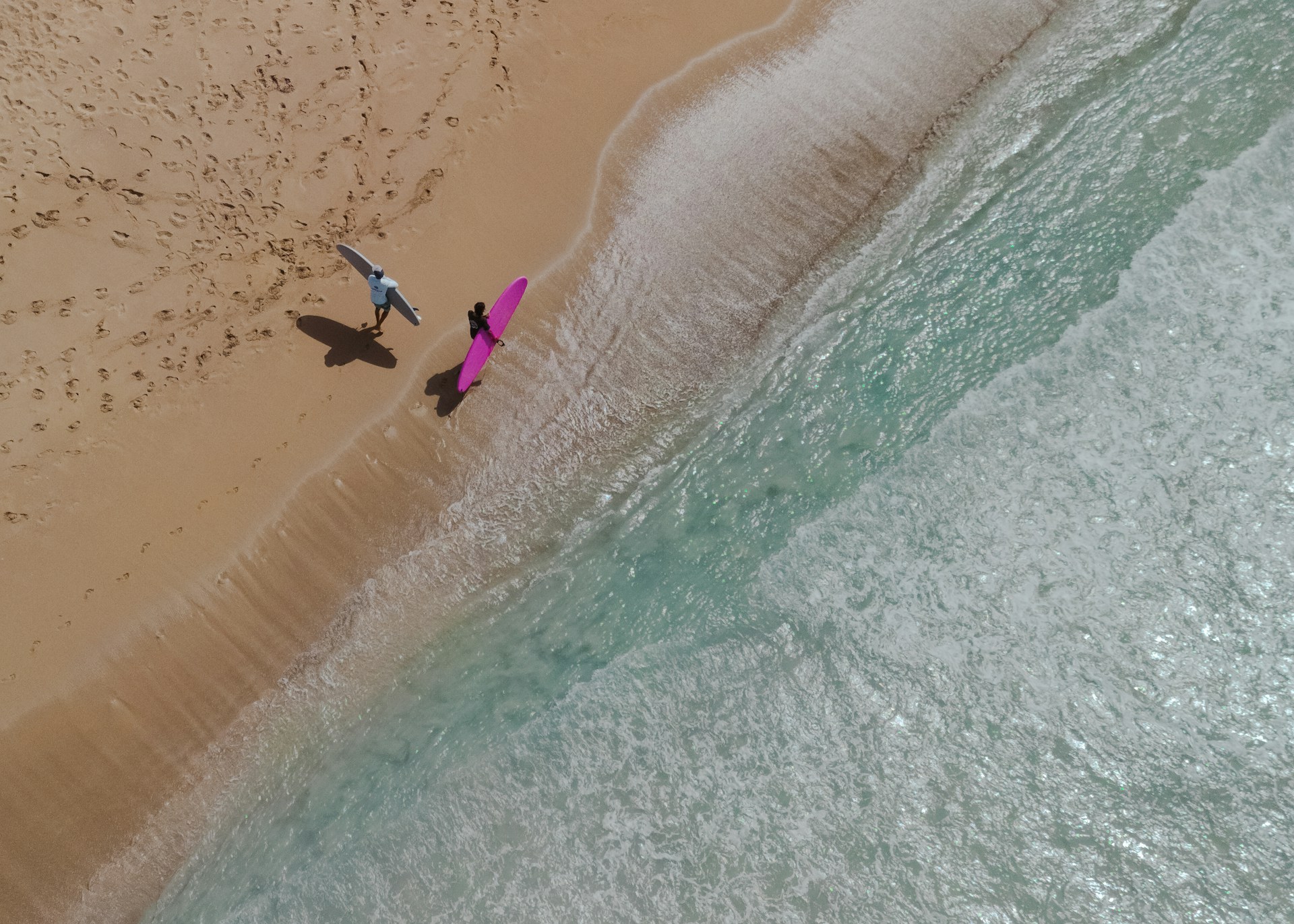 A group of people standing on top of a sandy beach