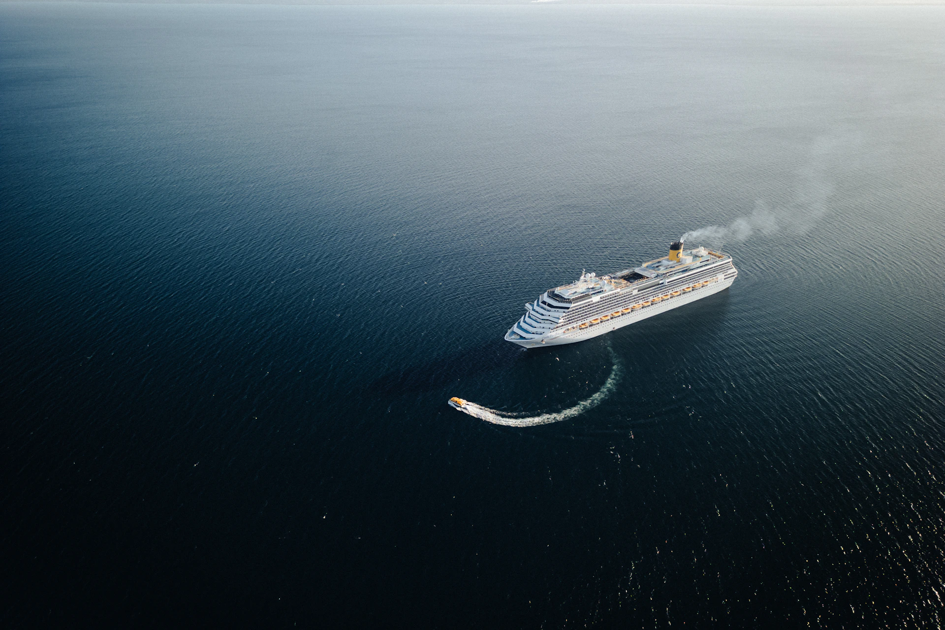A large white boat floating on top of a body of water