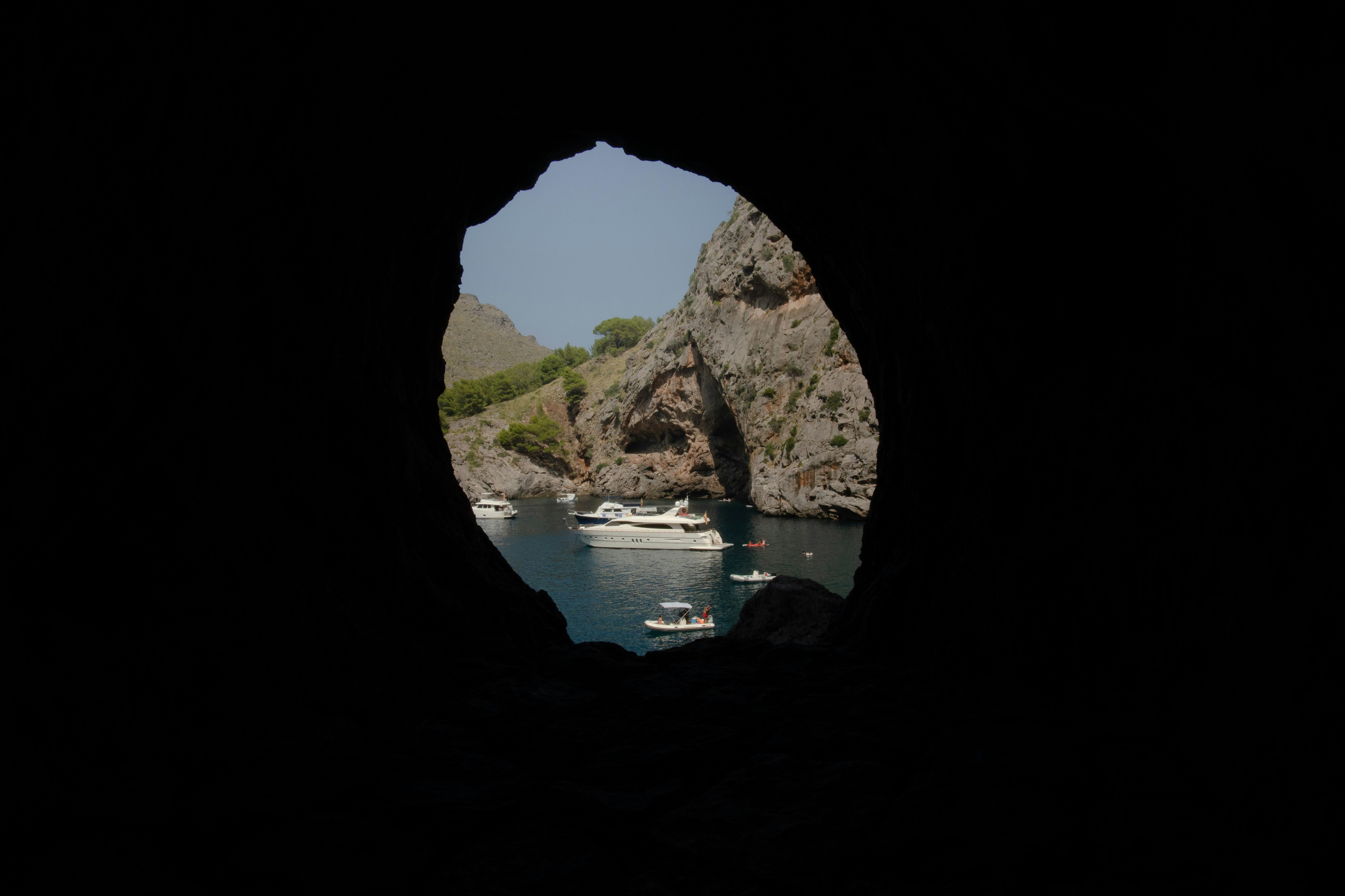 A view of a body of water through a hole in a rock