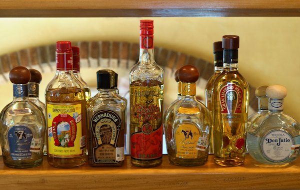 A wooden shelf filled with bottles of liquor — Tequila, Mexico