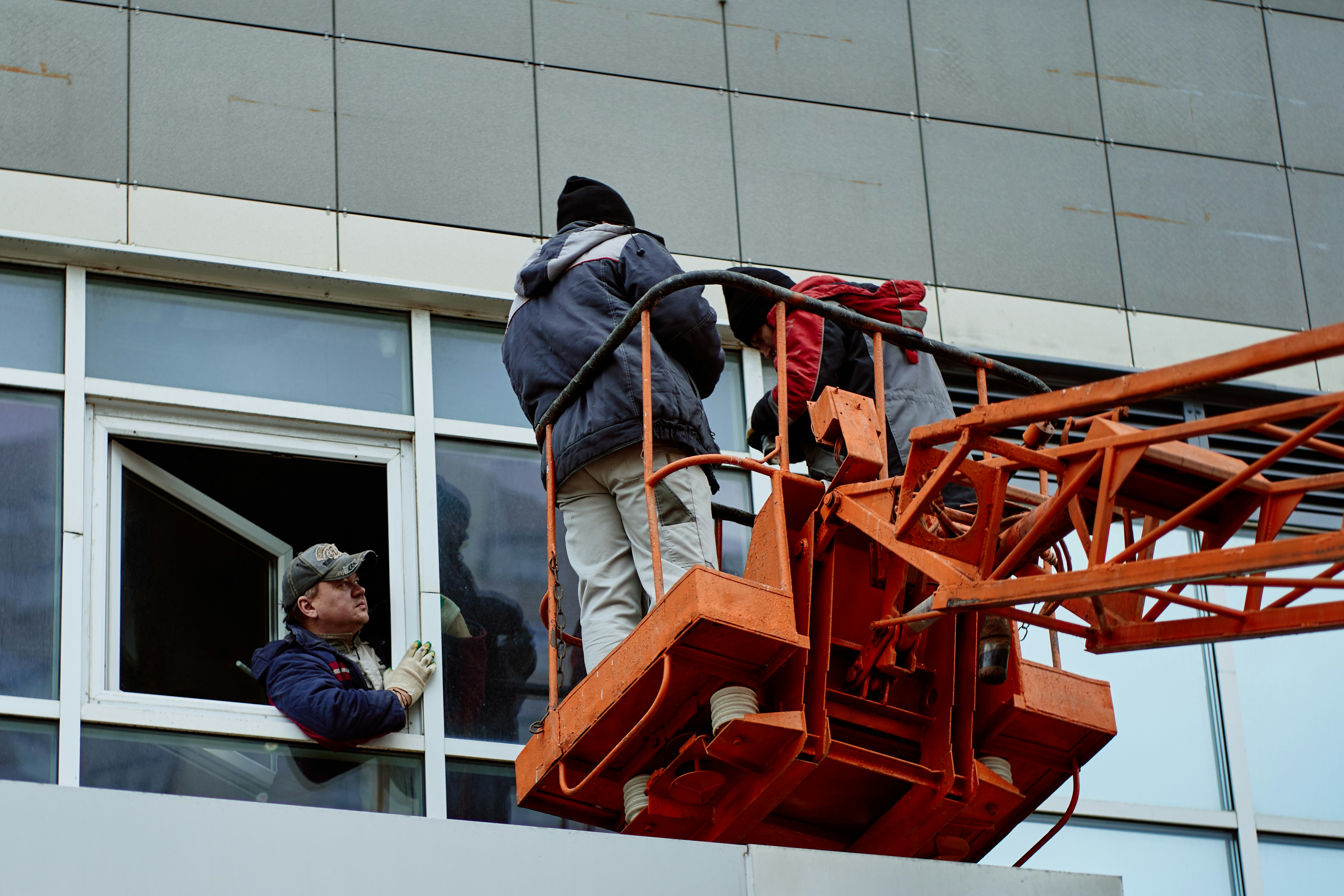 professional window installation team working on residential building
