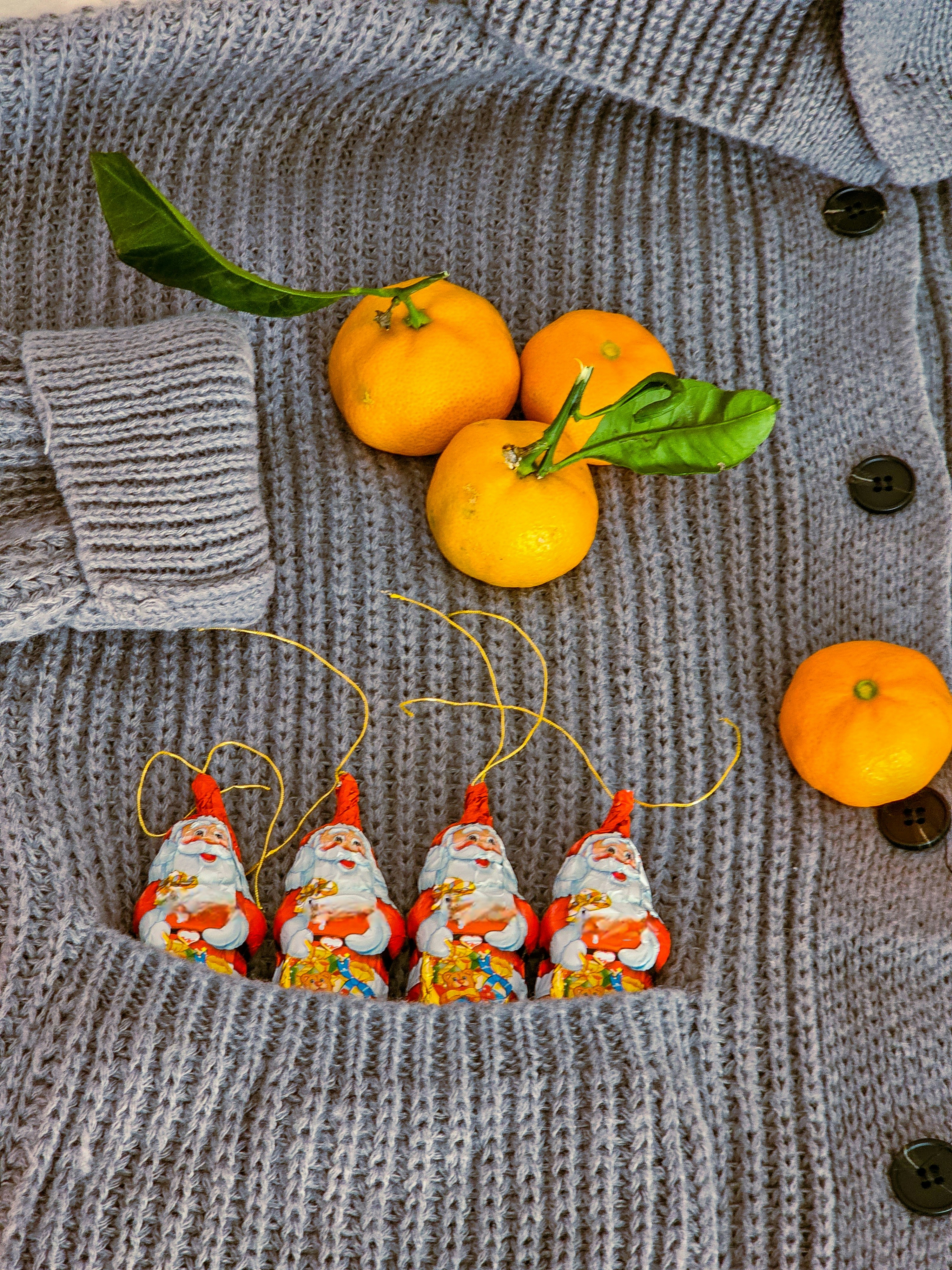 A sweater with oranges and other fruit on it