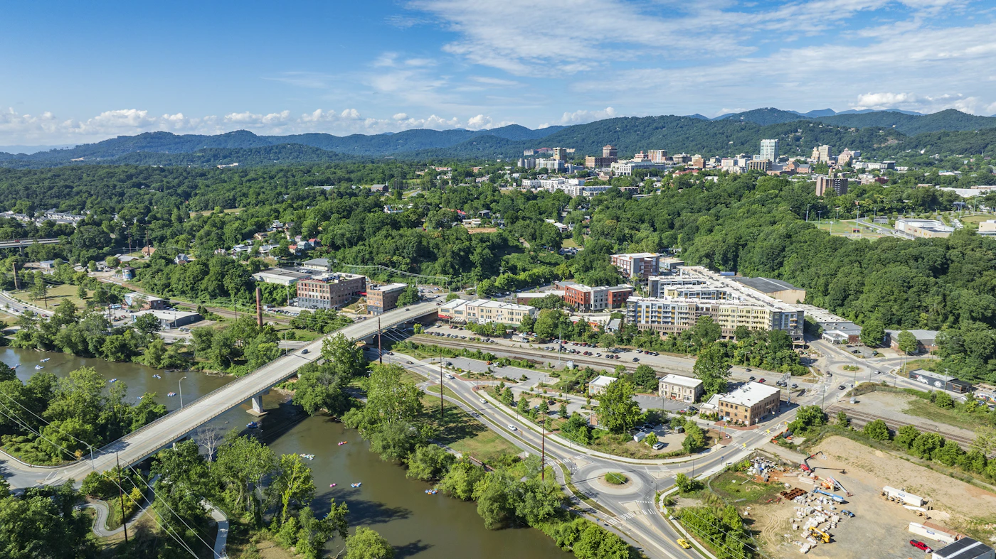 Aerial view of Asheville, North Carolina with mountains beyond