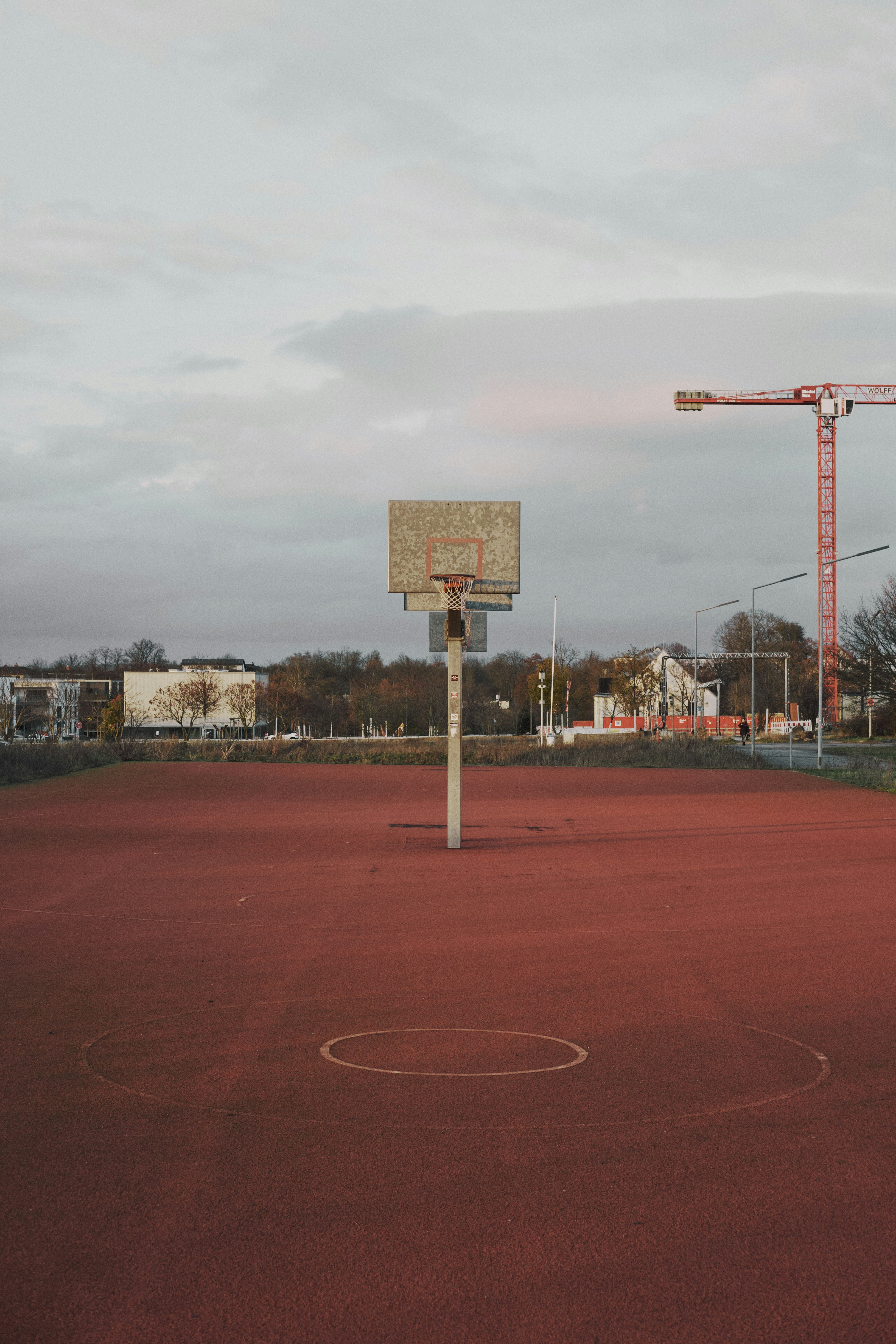A basketball court with a basketball hoop in the middle of it