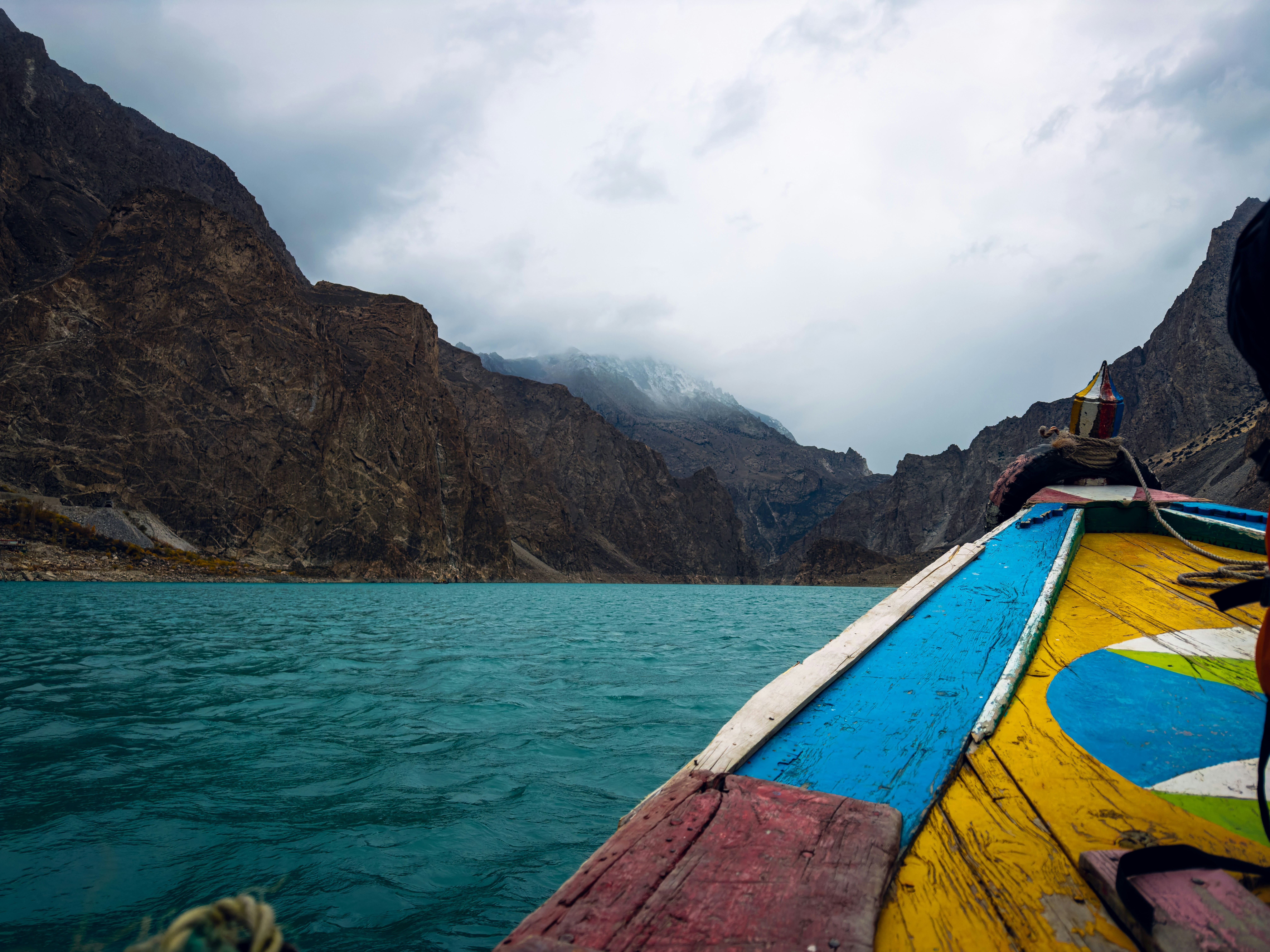 A man riding on the back of a boat on a lake