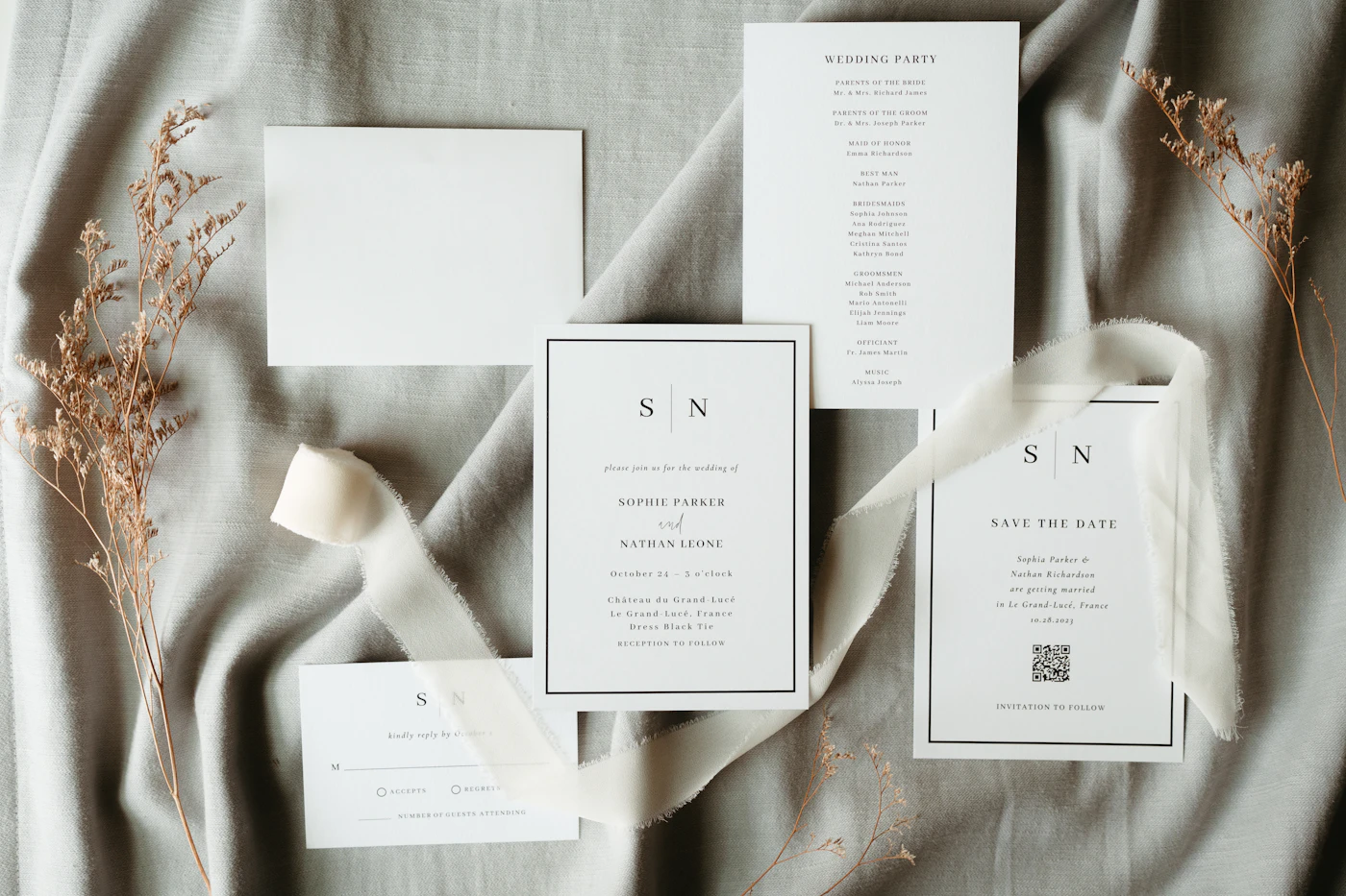 Step-by-step guide to DIY wedding invitations — A flatlay of a DIY wedding invitation suite with ribbons and wax seals.