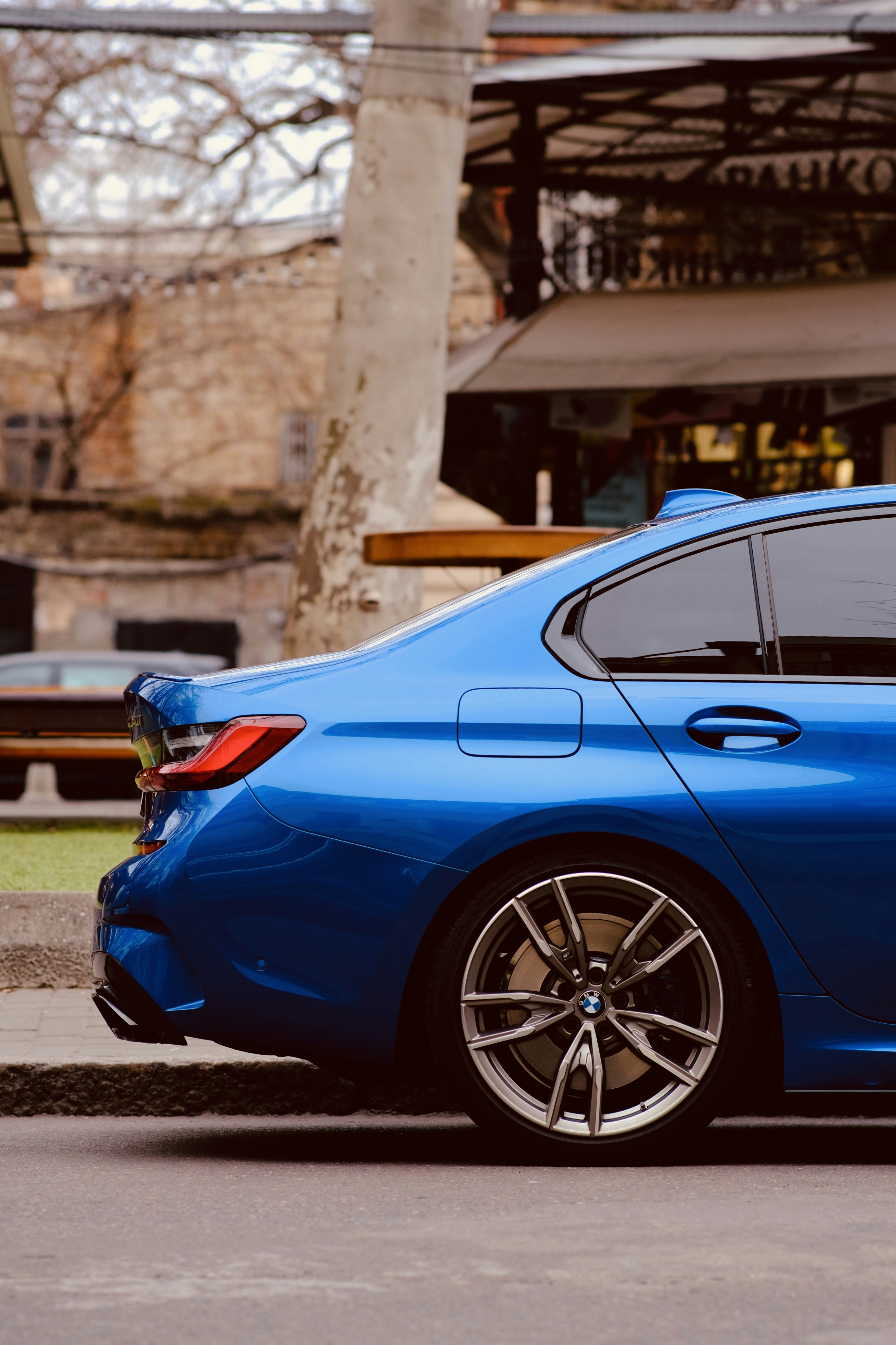 A blue car parked on the side of the road