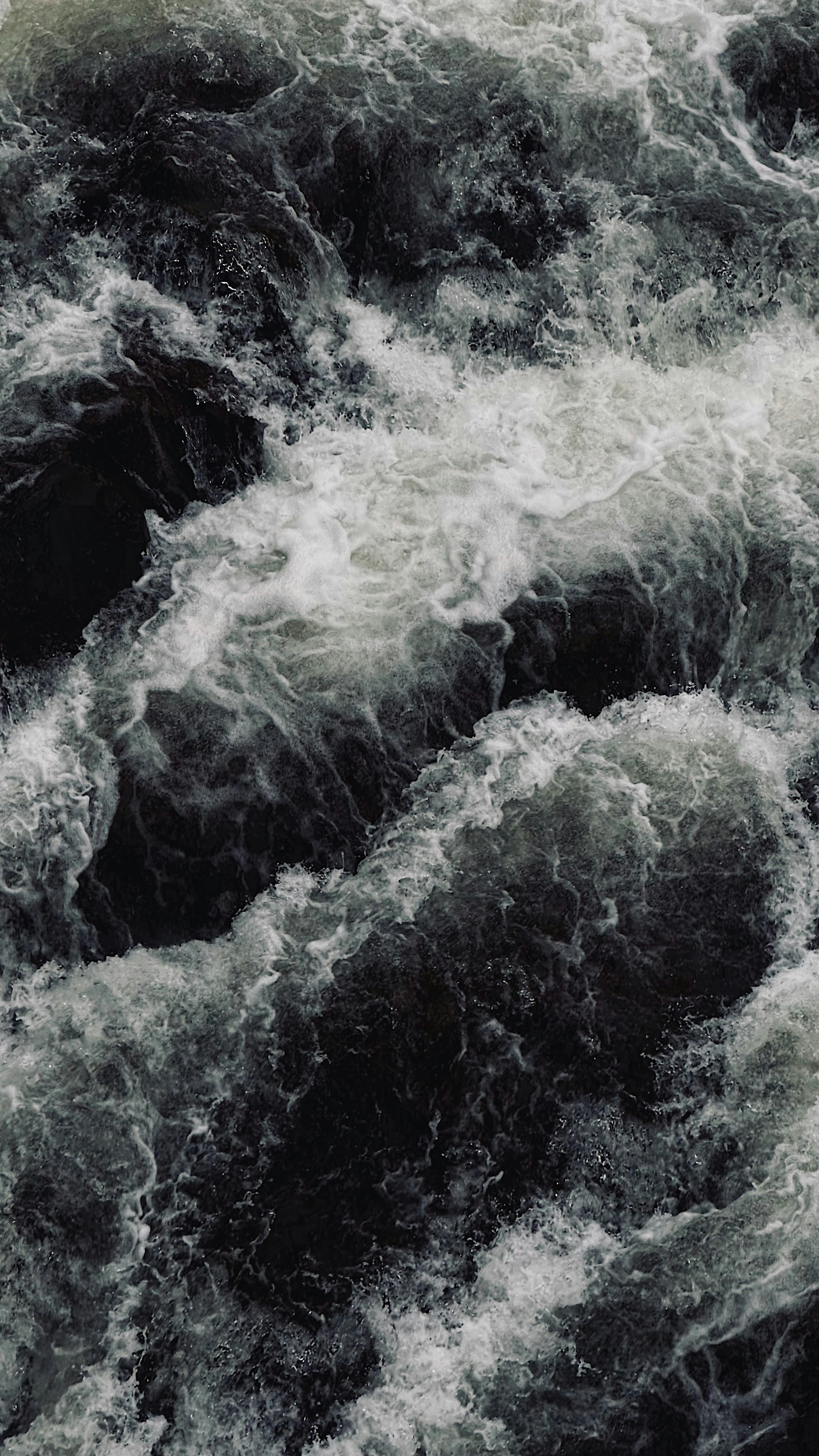 A man riding a surfboard on top of a wave