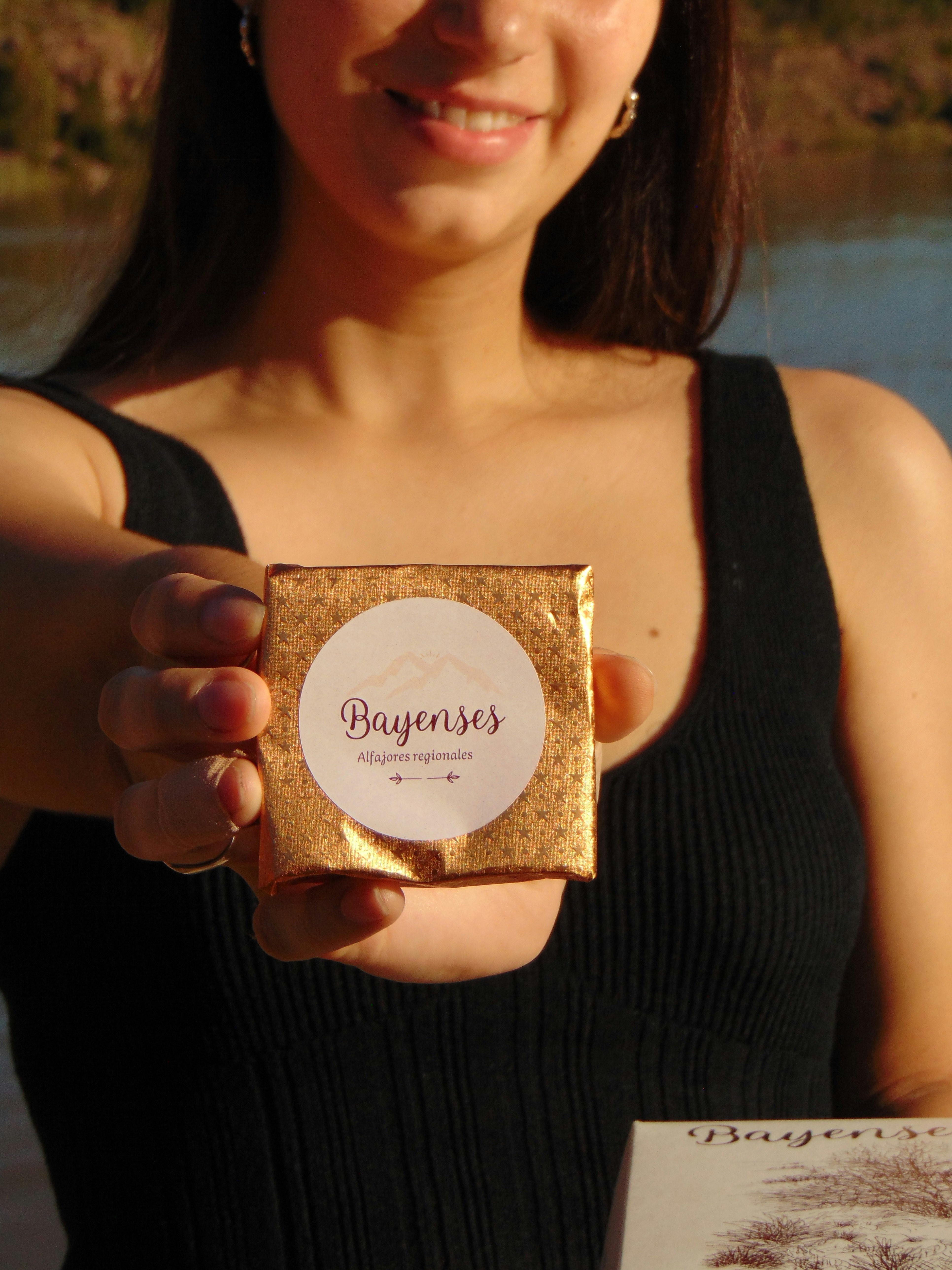 A woman holding up a piece of paper with a picture on it