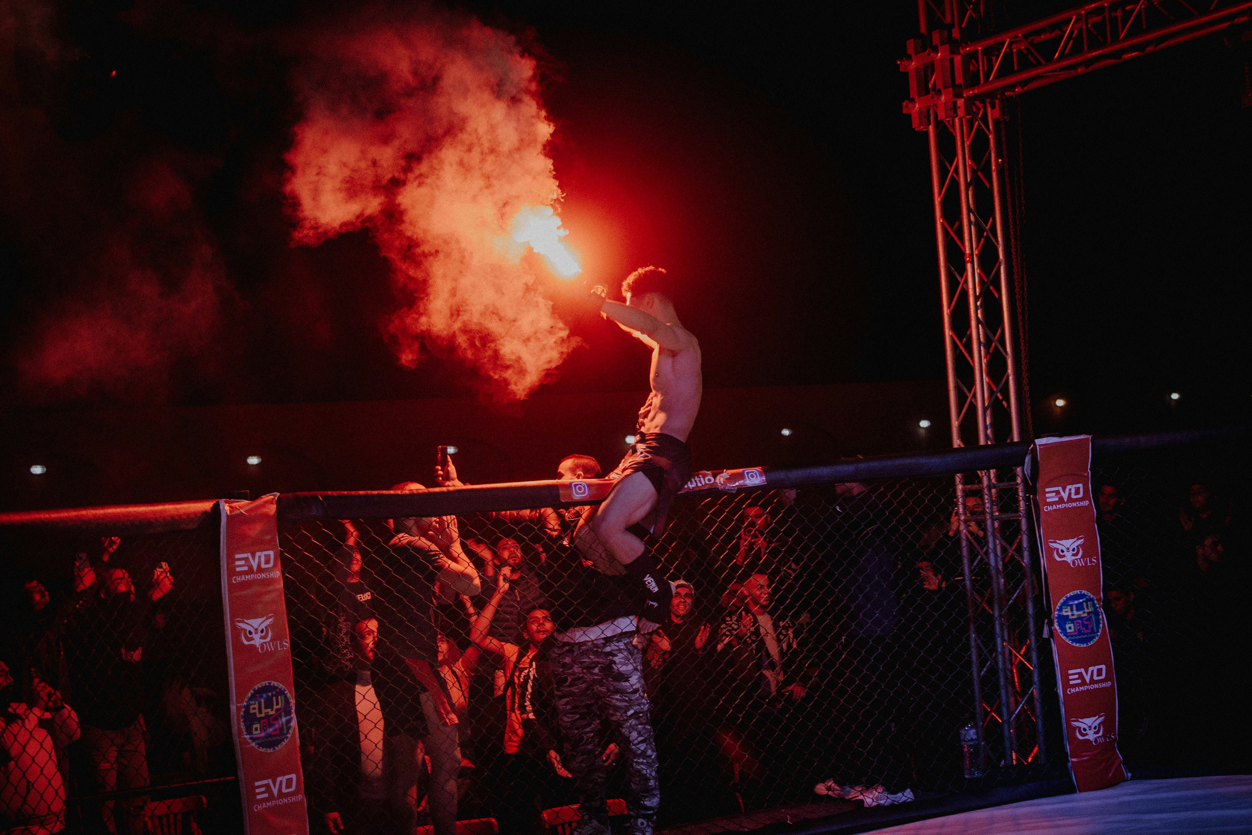 MMA athletes celebrating qualification, bright arena, team spirit and excitement