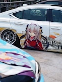 A car painted with anime characters on it